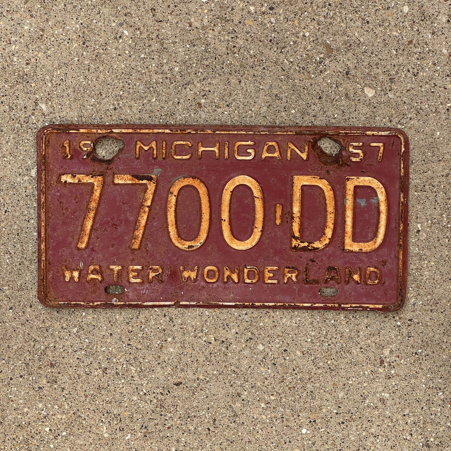 Photo of a 1957 Michigan License Plate Auto Tag Garage Decor Vintage 7700 DD