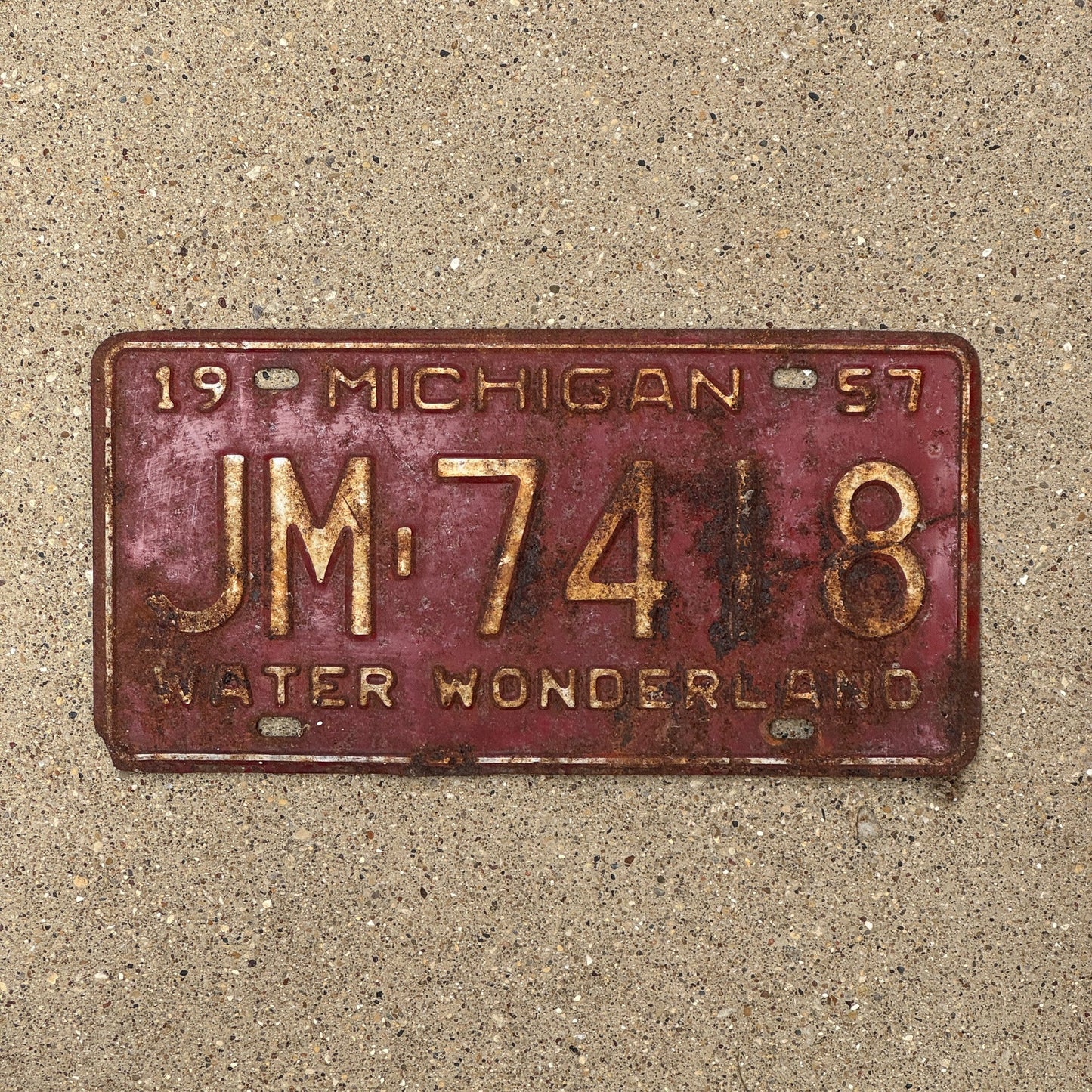 Photo of a 1957 Michigan License Plate Auto Tag Garage Decor Vintage JM 7418