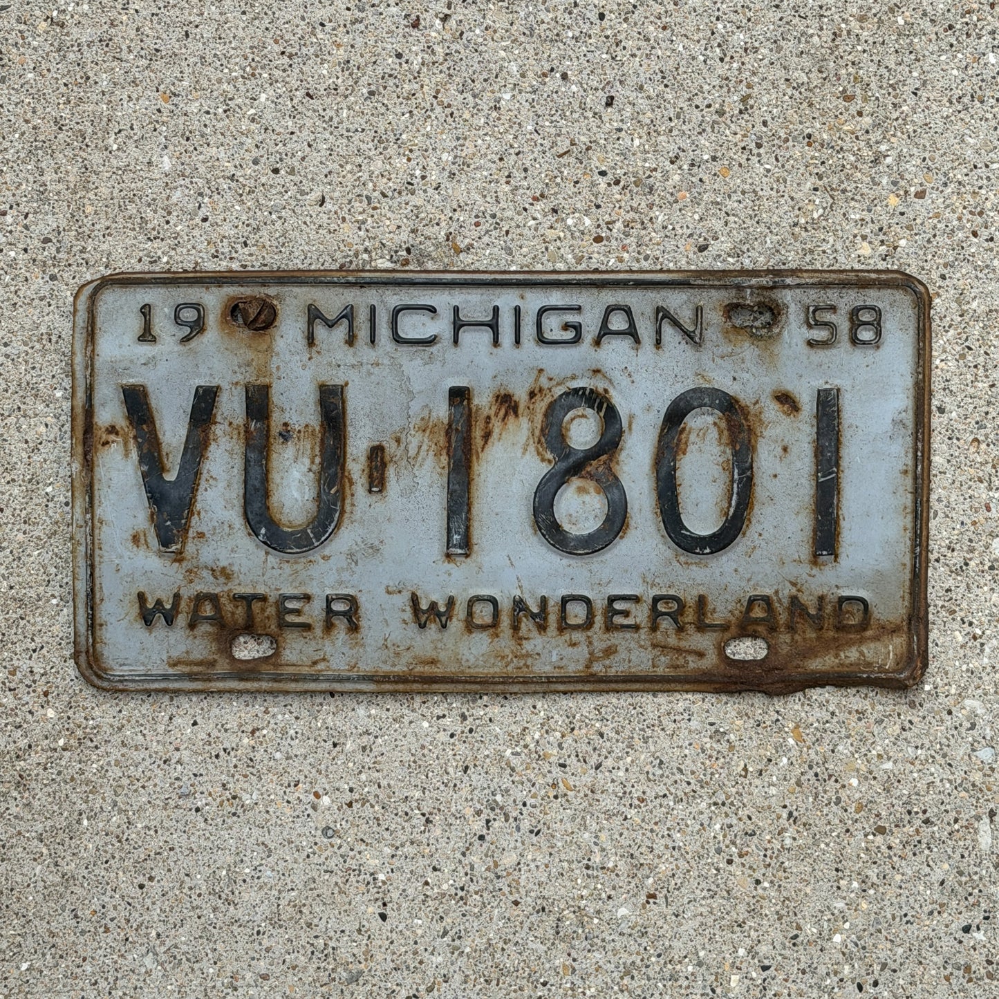 Photo of a 1958 Michigan License Plate Auto Tag Garage Decor Vintage VU 1801 with original patina