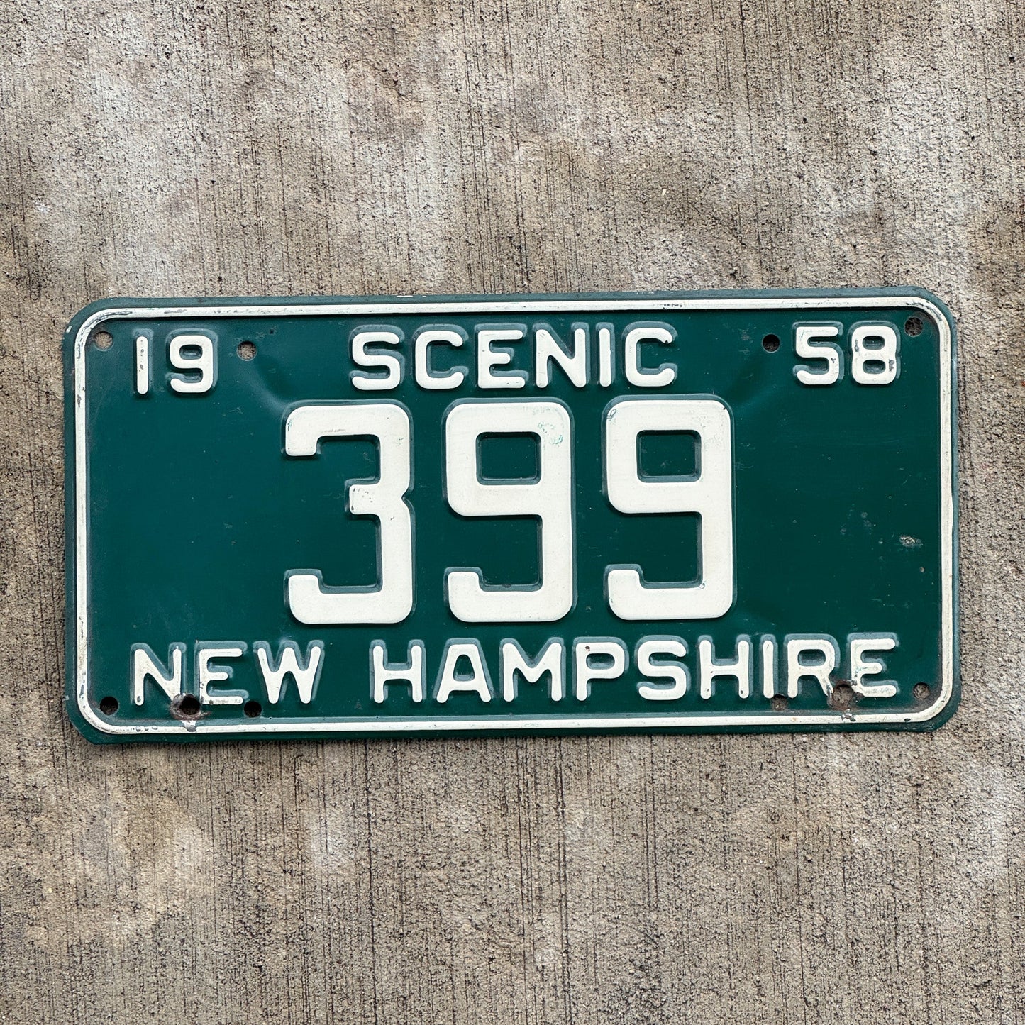 Photo of a 1958 New Hampshire License Plate Auto Tag Garage Decor Vintage Low Number Three Digit 399 with original patina