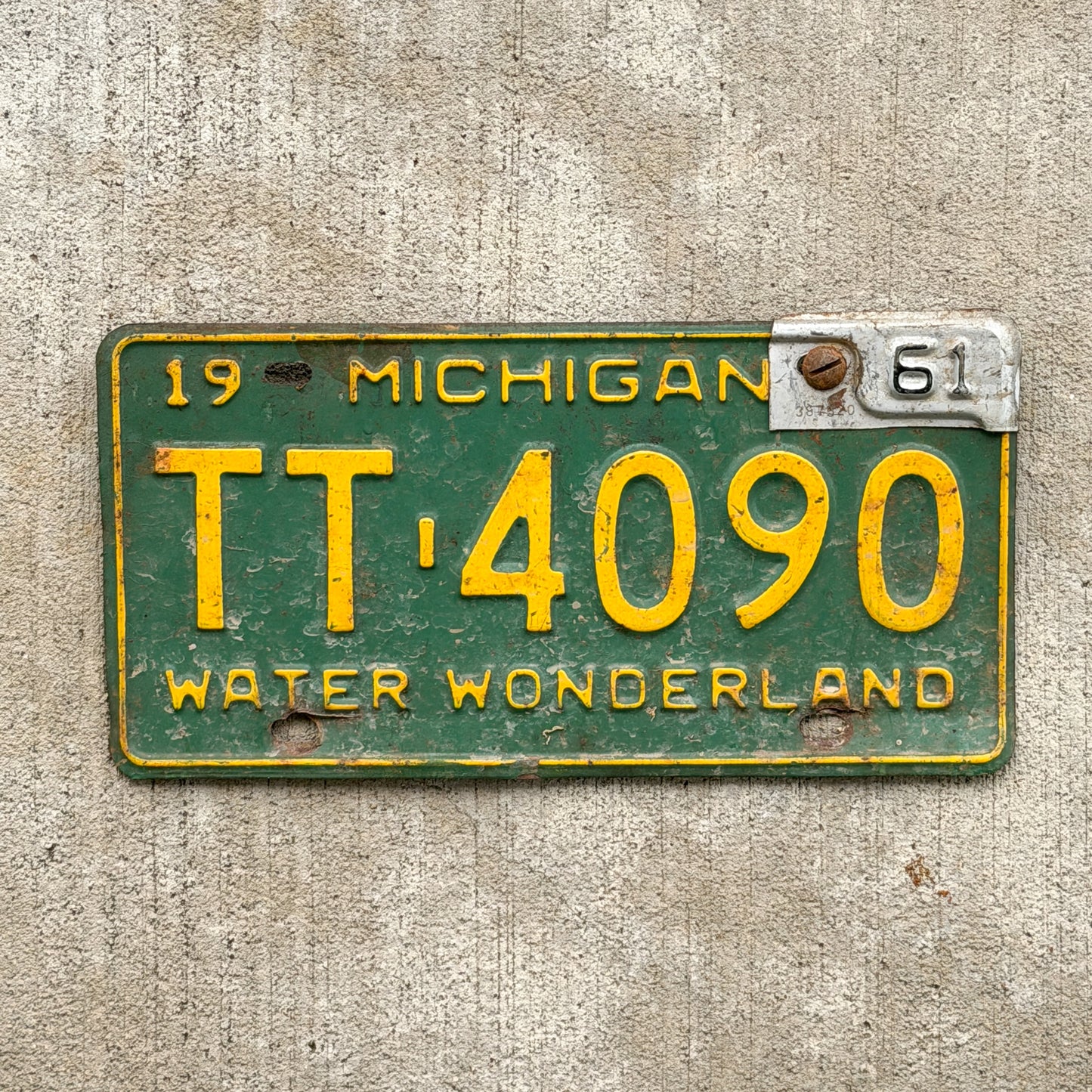 Photo of a 1959 1961 Michigan License Plate Auto Tag Garage Decor Vintage TT 4090 with original patina