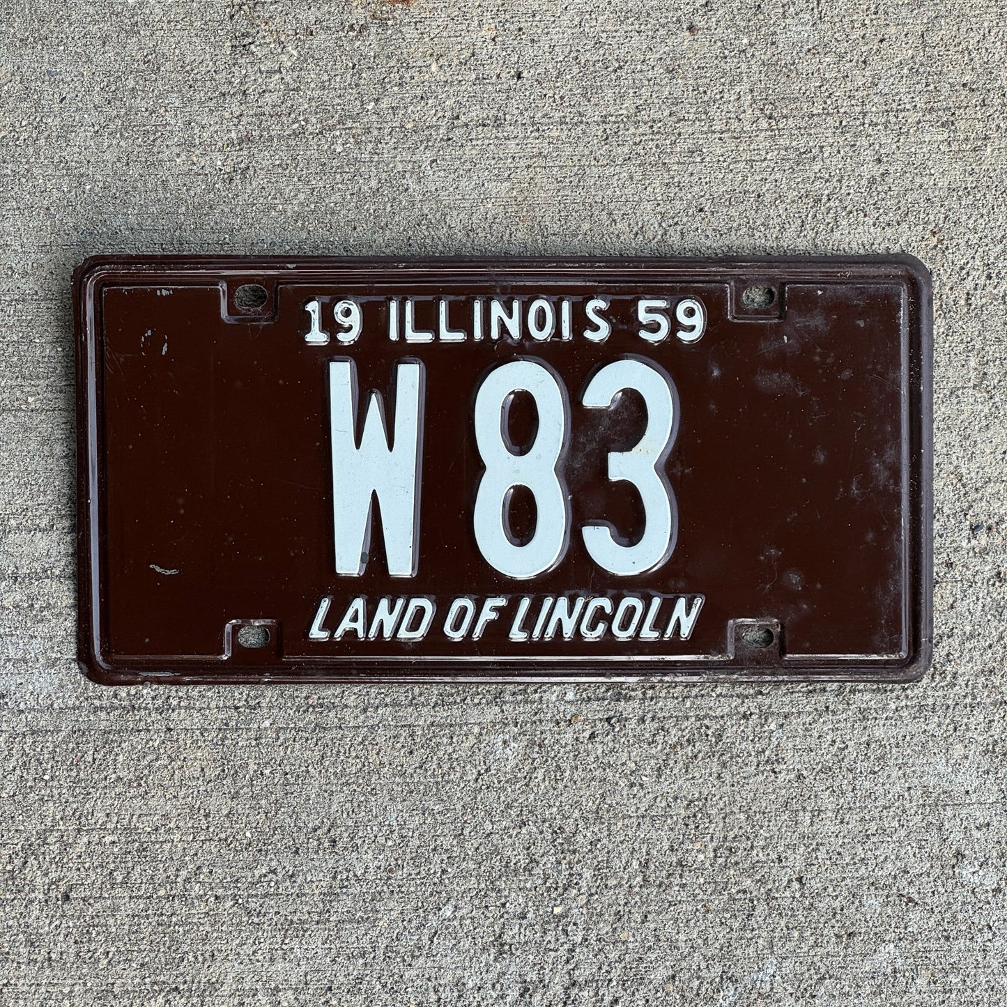 Photo of a 1959 Illinois Trailer License Plate Auto Tag Garage Decor Vintage Low Number Two Digit W 83 with original patina