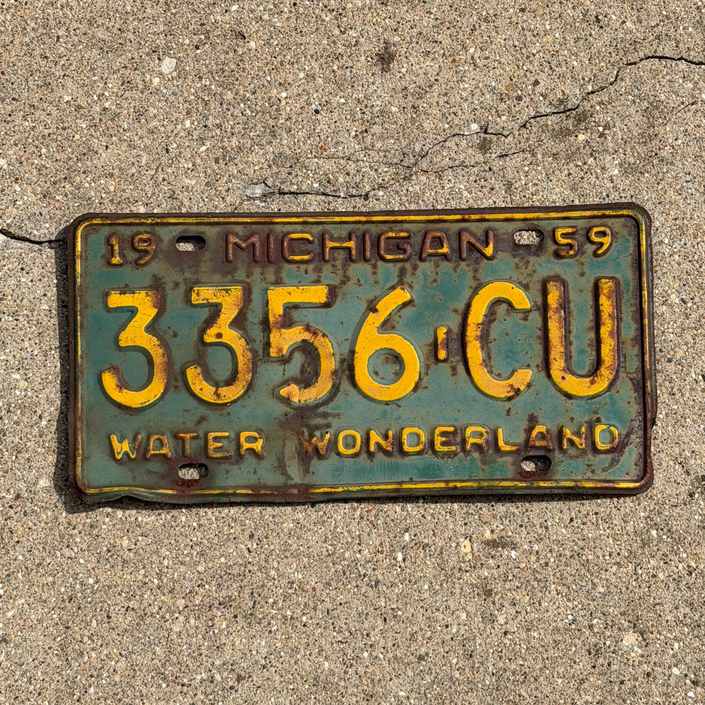Photo of a 1959 Michigan Commercial License Plate Auto Tag Garage Decor Vintage 3356 CU with original patina