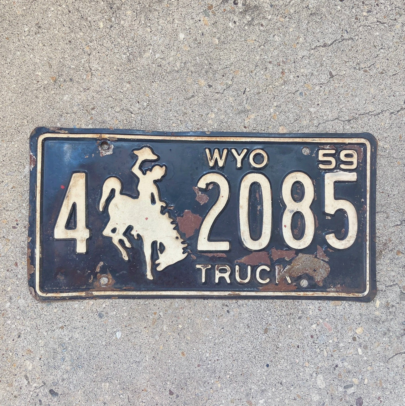 Photo of a 1959 Wyoming Truck License Plate Auto Tag Garage Decor Vintage Cowboy Rodeo Weed Smoking 4 2085 with original patina