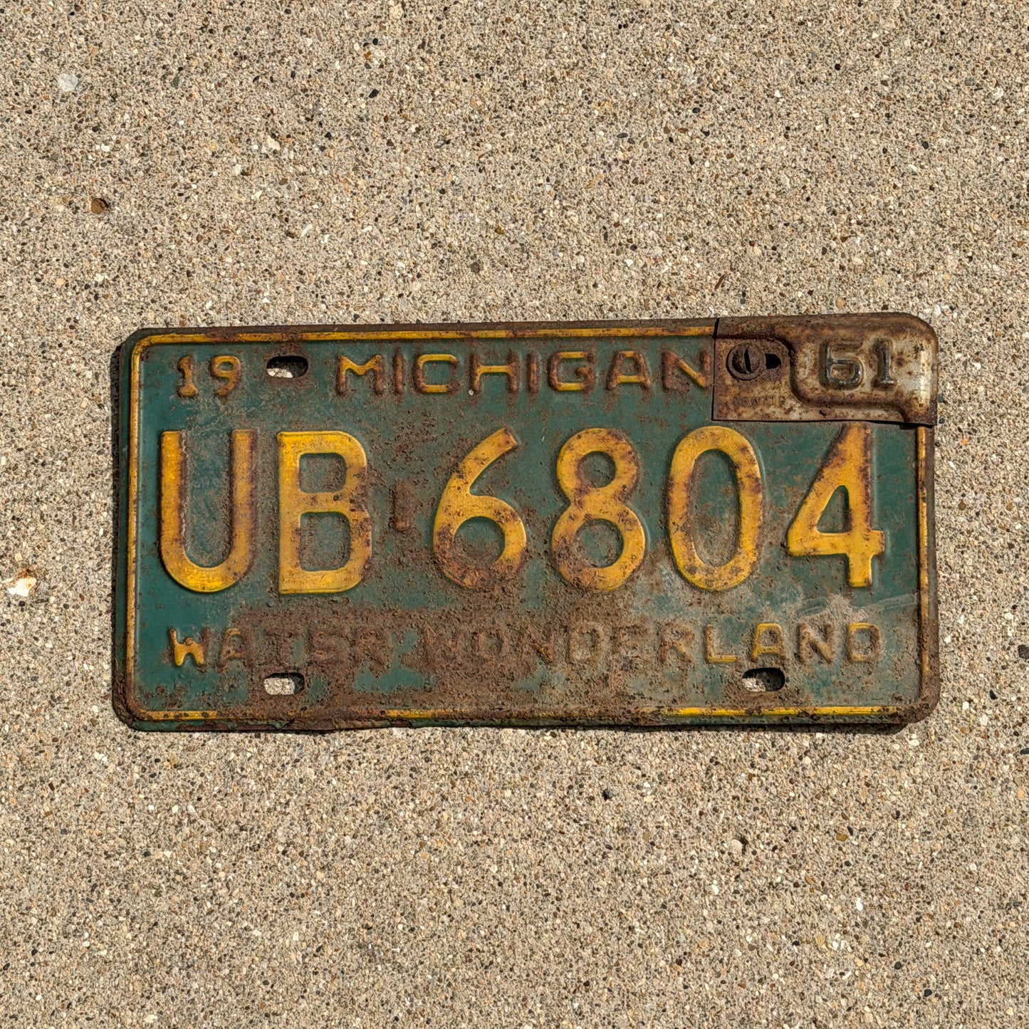 Photo of a 1960 1961 Michigan License Plate Auto Tag Garage Decor Vintage UB 6804 with original patina