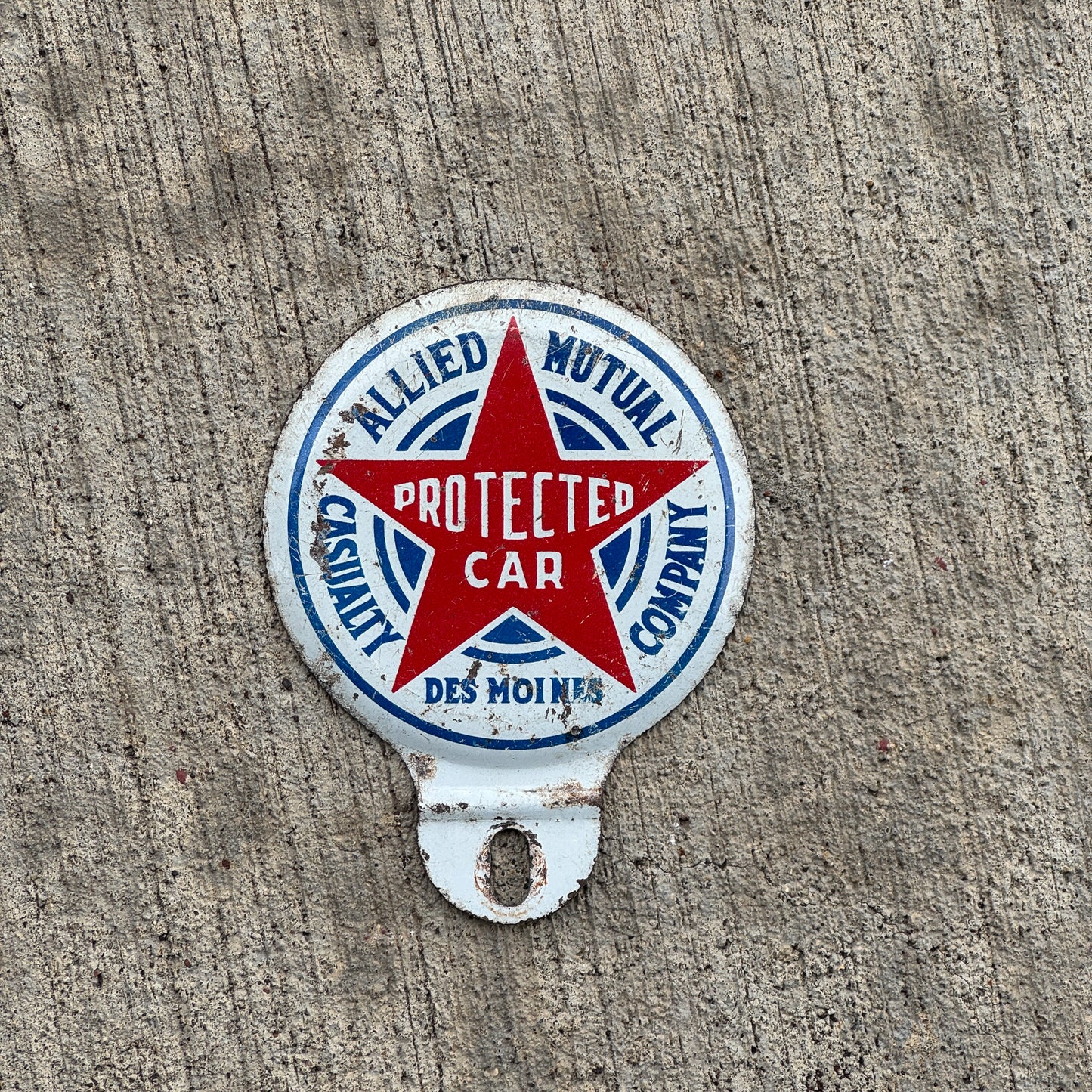 Photo of a 1960 Era Allied Mutual Insurance Des Moines Iowa License Plate Topper Auto Tag Garage Decor Vintage with original patina