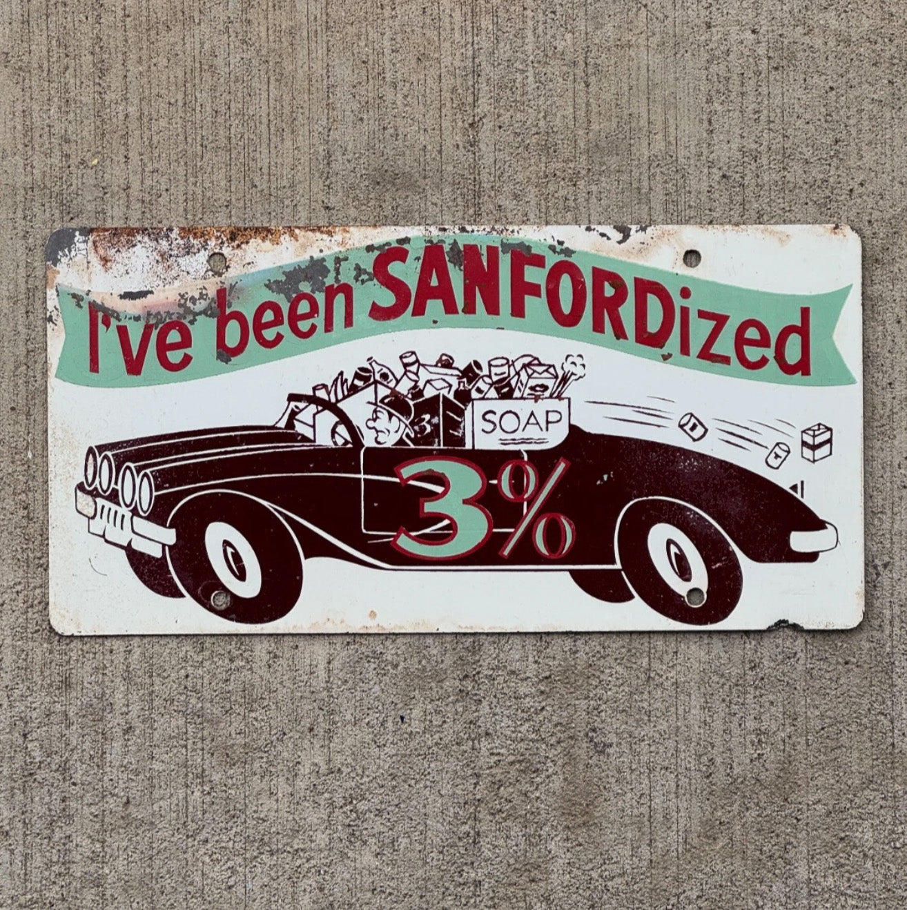 Photo of a 1960 Era Sanfordized Car Soap Booster License Plate Auto Tag Garage Decor Vintage Bathroom Decor with original patina