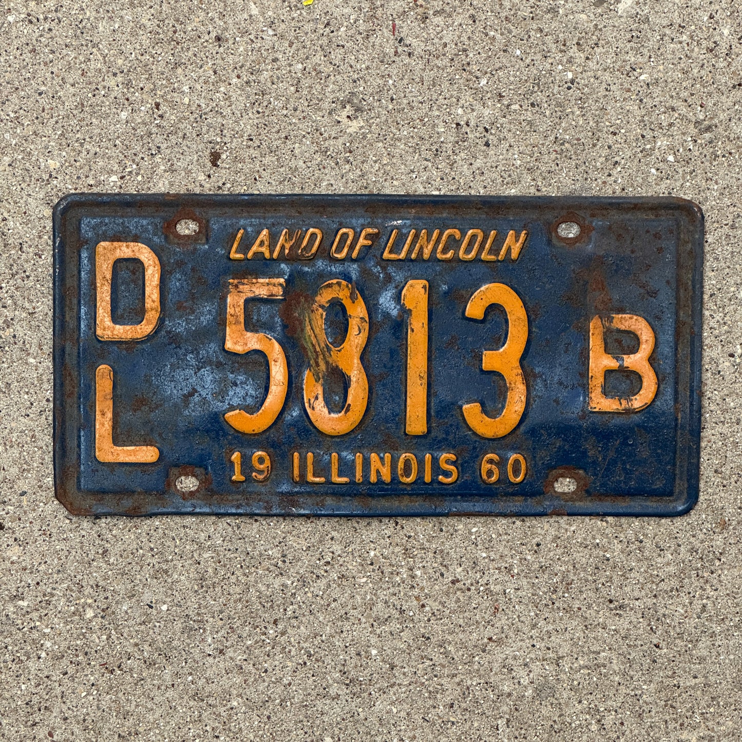 Photo of a 1960 Illinois Dealer License Plate Auto Tag 1 Vintage Garage Orange Blue 5813 B with original patina