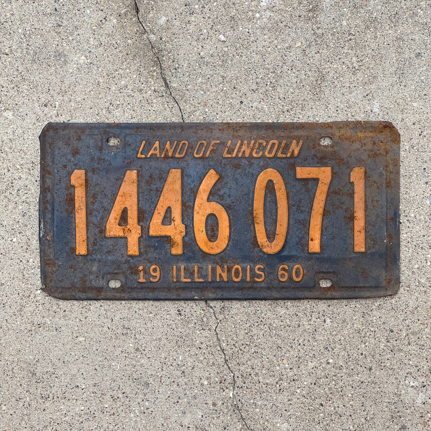 Photo of a 1960 Illinois License Plate Auto Tag 1 Vintage Garage Orange Blue 1 446 071 with original patina
