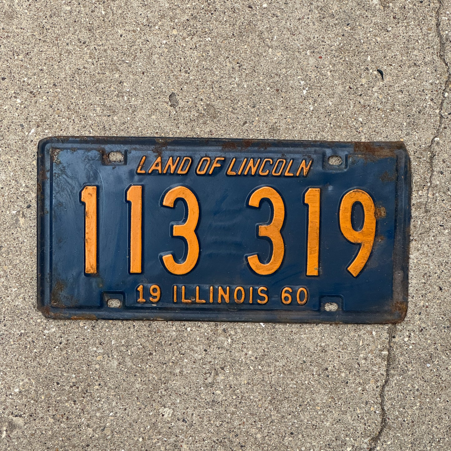 Photo of a 1960 Illinois License Plate Auto Tag 1 Vintage Garage Orange Blue 113 319 with original patina