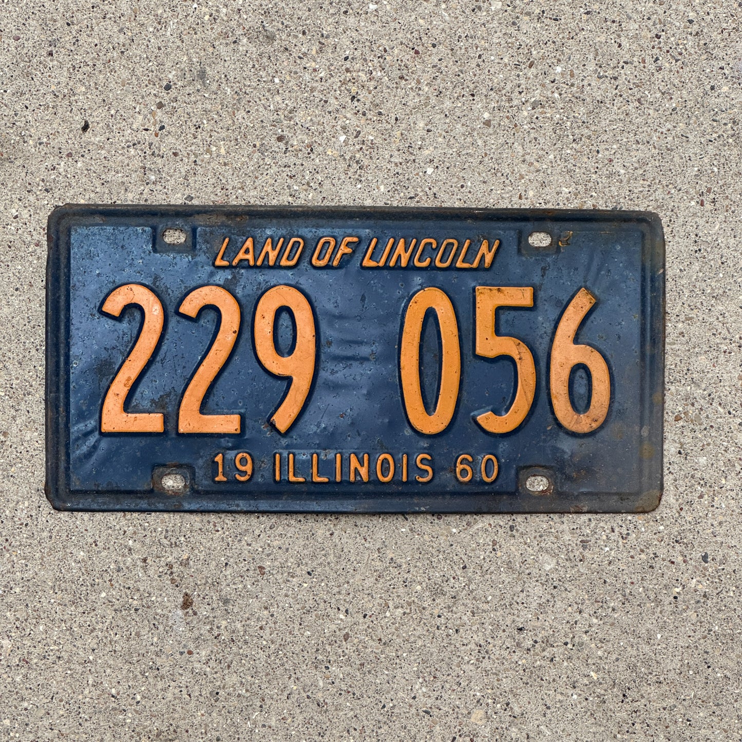 Photo of a 1960 Illinois License Plate Auto Tag 1 Vintage Garage Orange Blue 229 056 with original patina