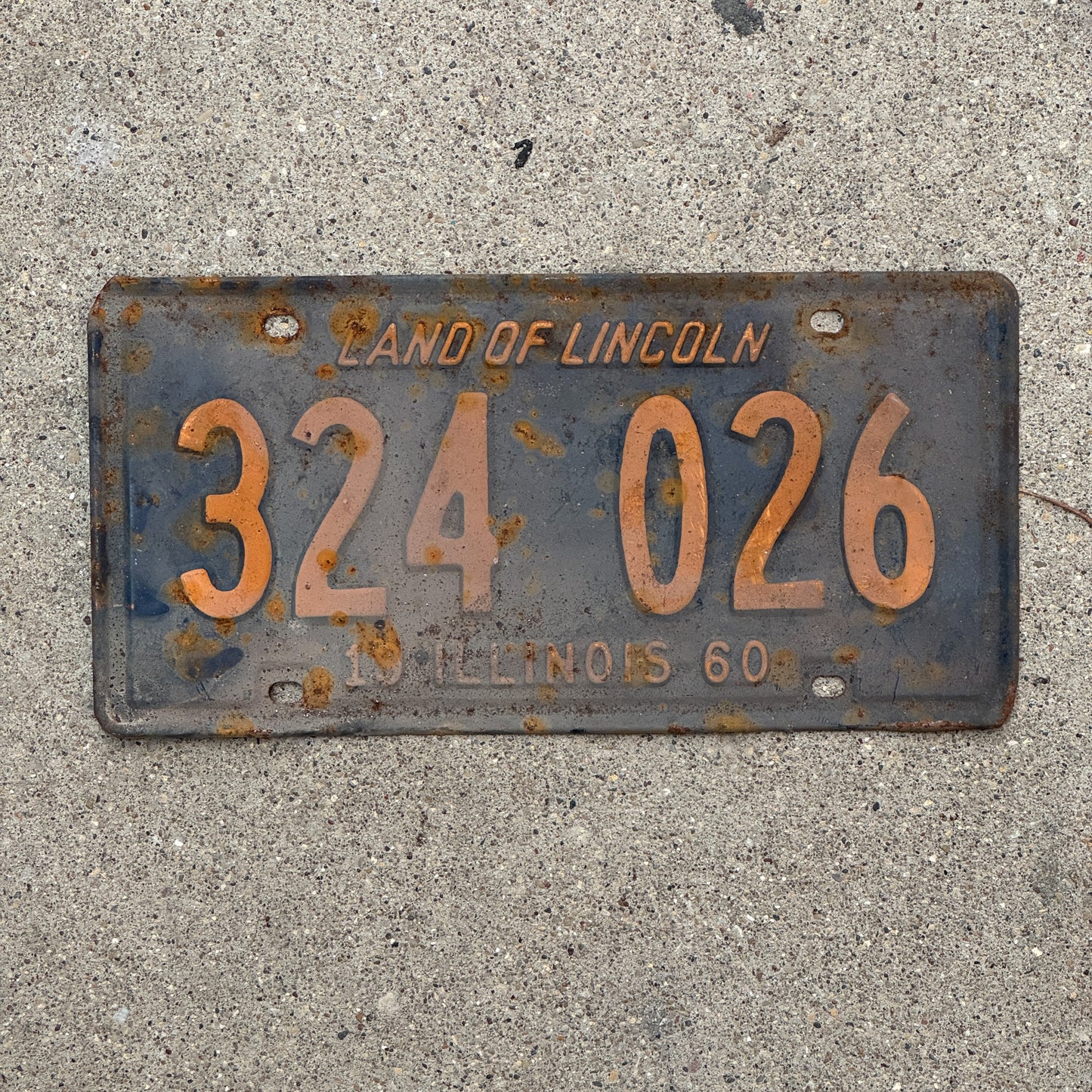 Photo of a 1960 Illinois License Plate Auto Tag 1 Vintage Garage Orange Blue 324 026 with original patina
