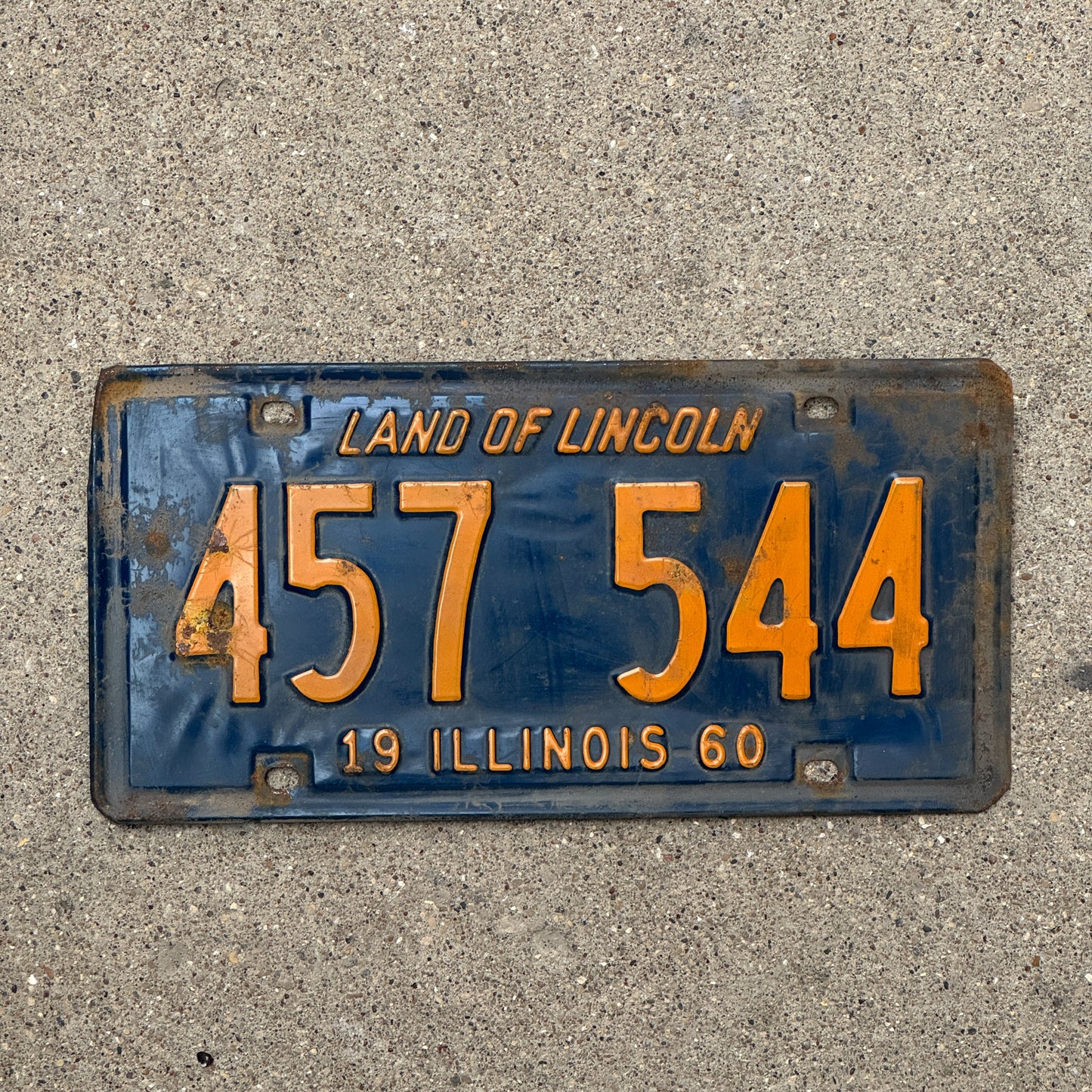 Photo of a 1960 Illinois License Plate Auto Tag 1 Vintage Garage Orange Blue 457 544 with original patina