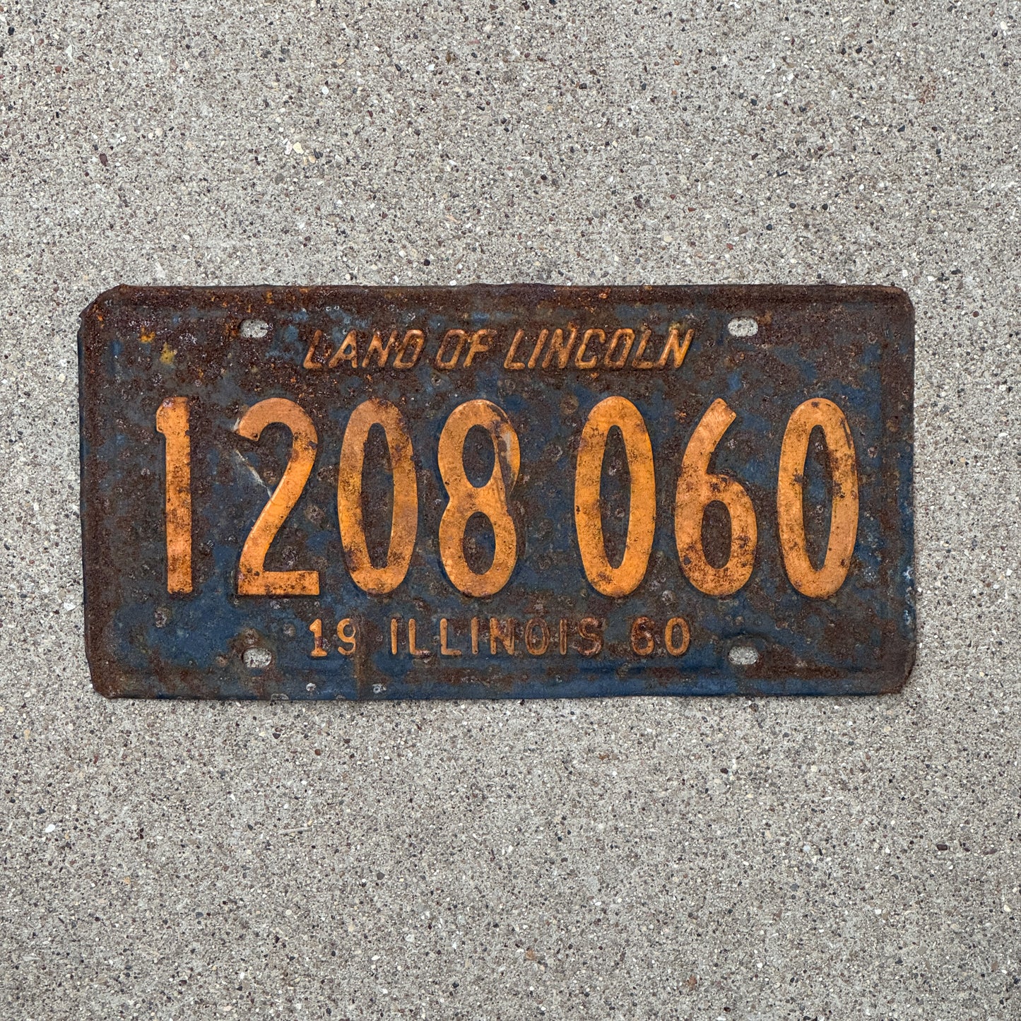 Photo of a 1960 Illinois License Plate Auto Tag 2 Vintage Garage Orange Blue 1 208 060 with original patina