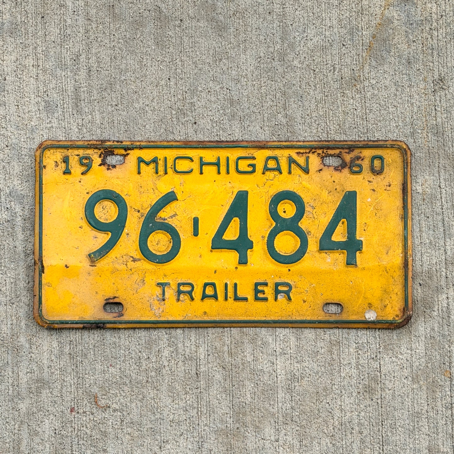 Photo of a 1960 Michigan Trailer License Plate Auto Tag Garage Decor Vintage 96 484 with original patina