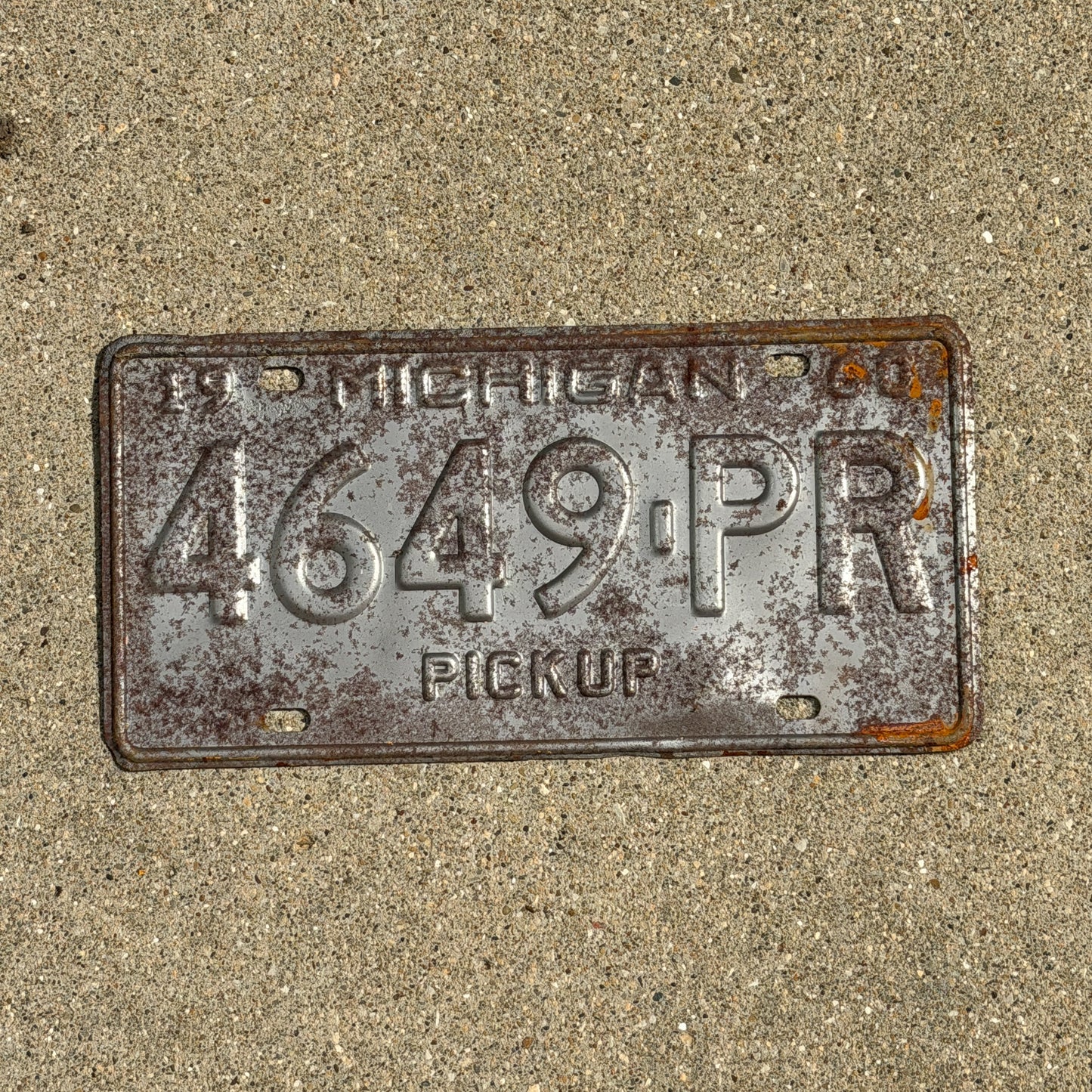 Photo of a 1960 Michigan Truck License Plate Auto Tag Garage Decor Vintage Pickup 4649 PR with original patina