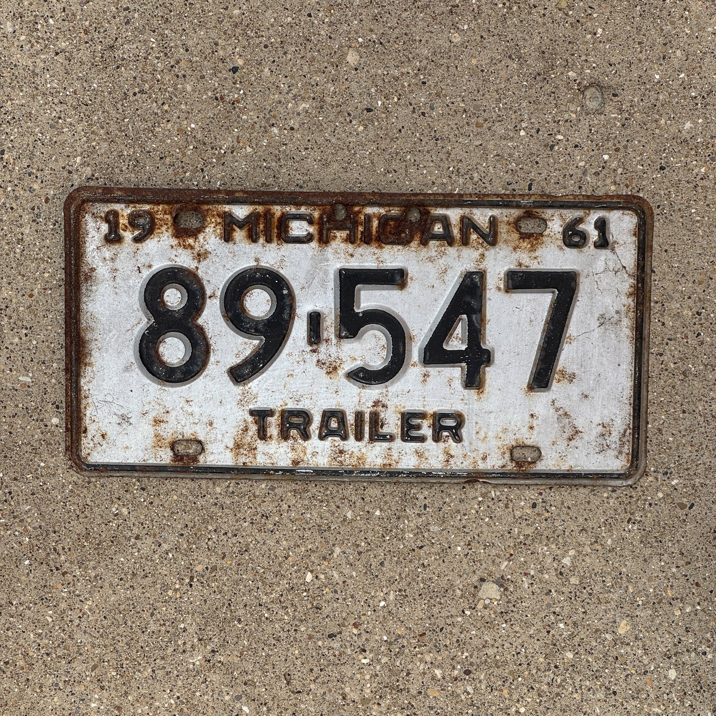 Photo of a 1961 Michigan Trailer License Plate Auto Tag Garage Decor Vintage 89547