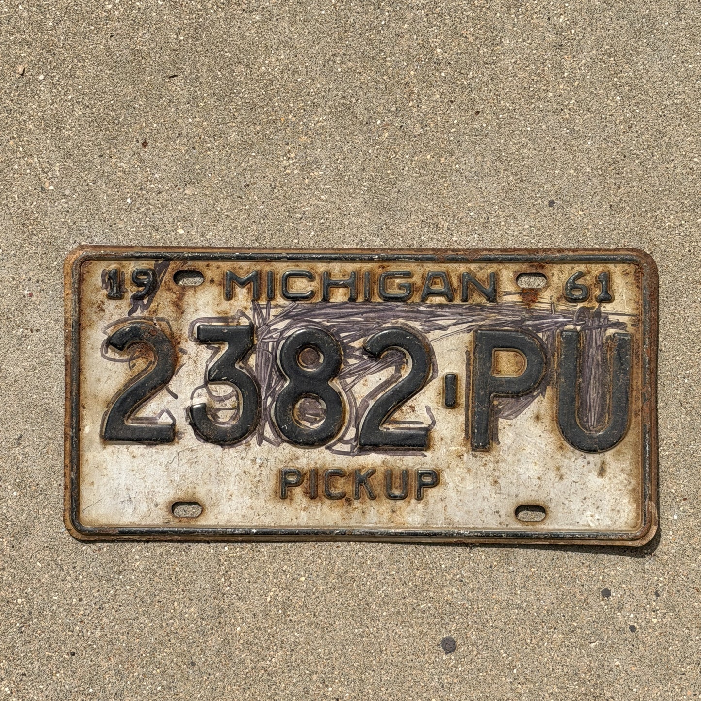 Photo of a 1961 Michigan Truck License Plate Auto Tag Garage Decor Vintage Pickup 2382 PU with original patina