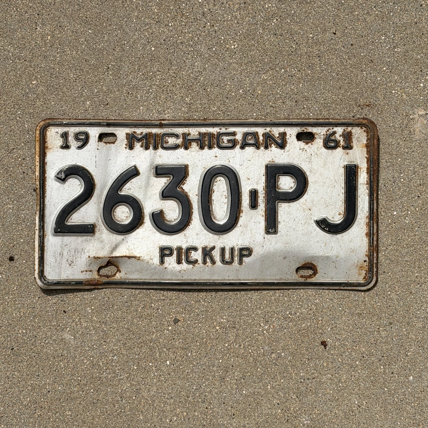 Photo of a 1961 Michigan Truck License Plate Auto Tag Garage Decor Vintage Pickup 2630 PJ with original patina