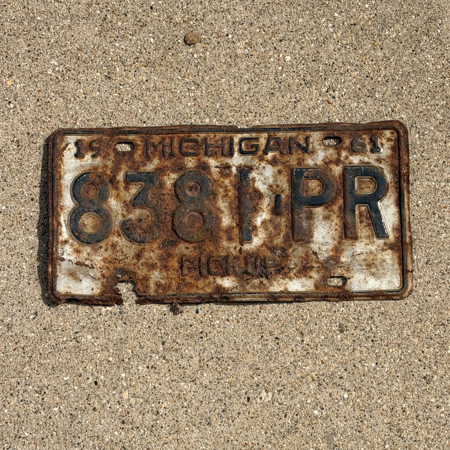 Photo of a 1961 Michigan Truck License Plate Auto Tag Garage Decor Vintage Pickup 8381 PR with original patina