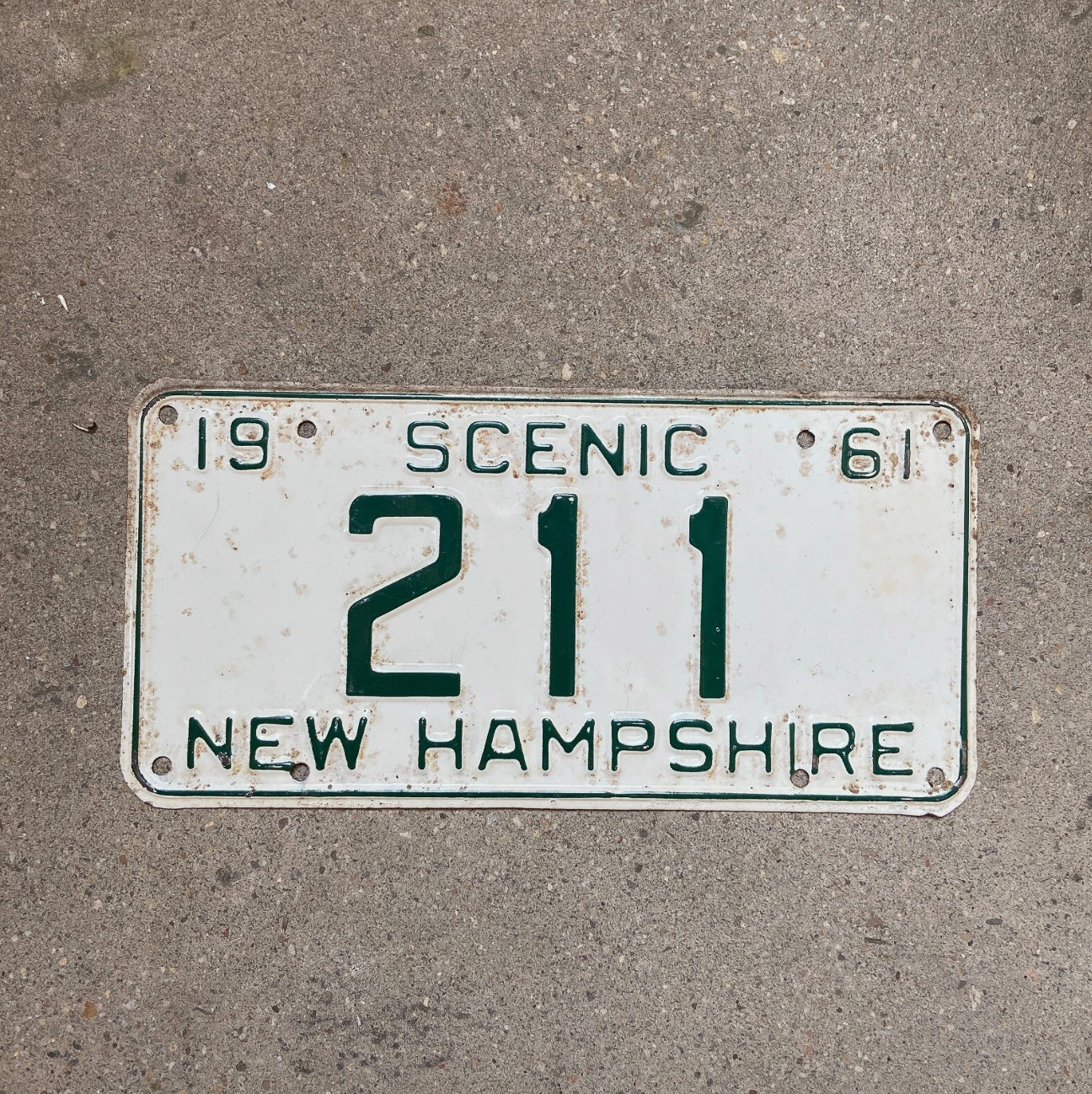 Photo of a 1961 New Hampshire License Plate Auto Tag Garage Decor Vintage Low Number Three Digit 211 with original patina