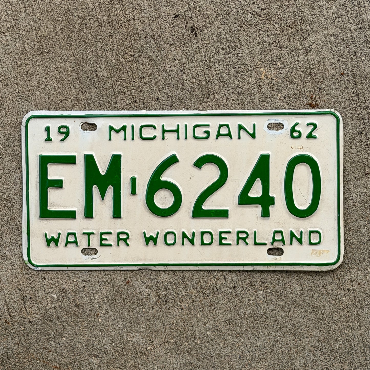 Photo of a 1962 Michigan License Plate Auto Tag Garage Decor Vintage EM 6240 with original patina