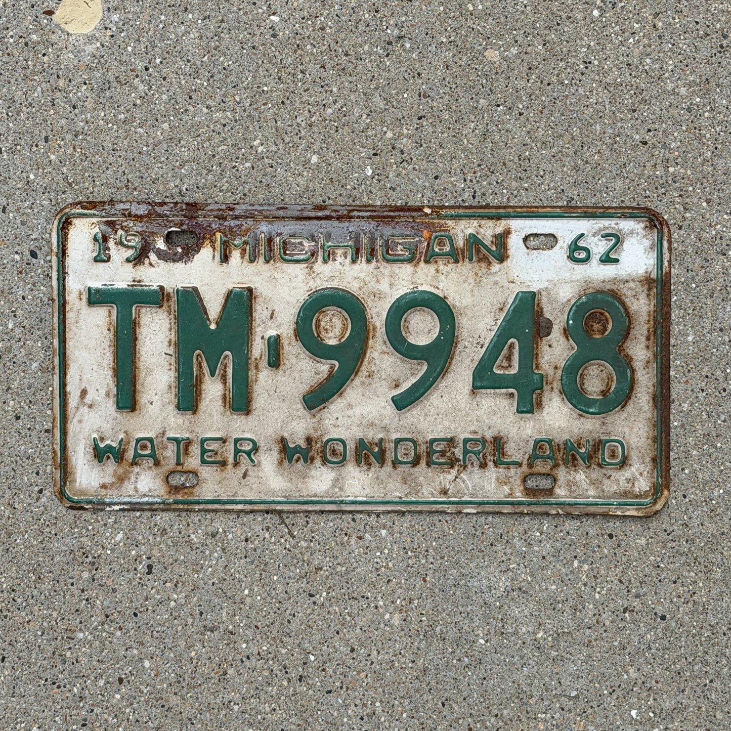 Photo of a 1962 Michigan License Plate Auto Tag Garage Decor Vintage TM 9948 with original patina