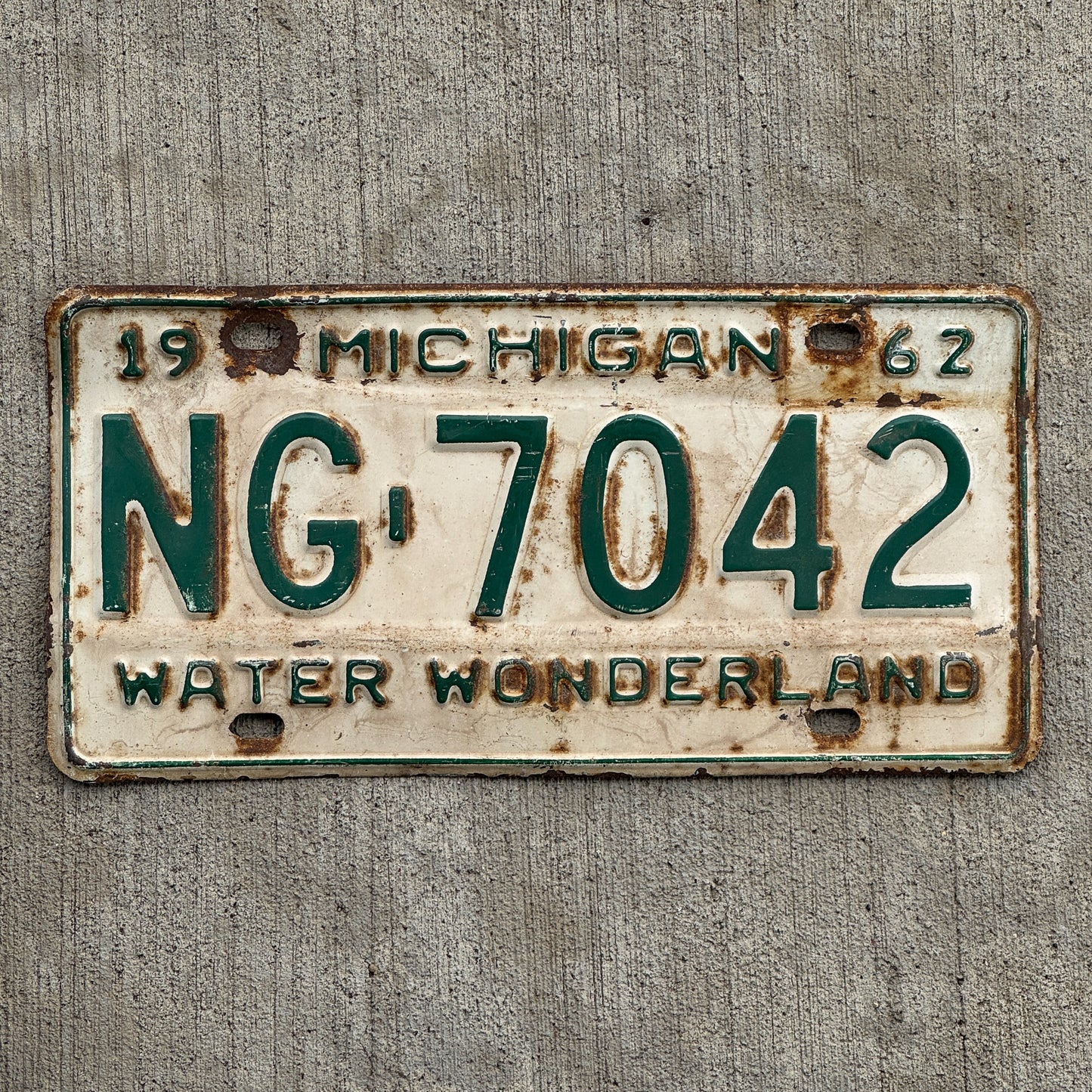 Photo of a 1962 Michigan License Plate Auto Tag Garage Decor Vintage Washtenaw County NG 7042 with original patina