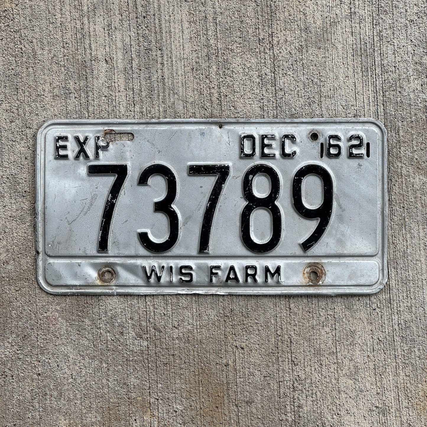 Photo of a 1962 Wisconsin Farm License Plate Auto Tag 1 Vintage Garage 73789 with original patina
