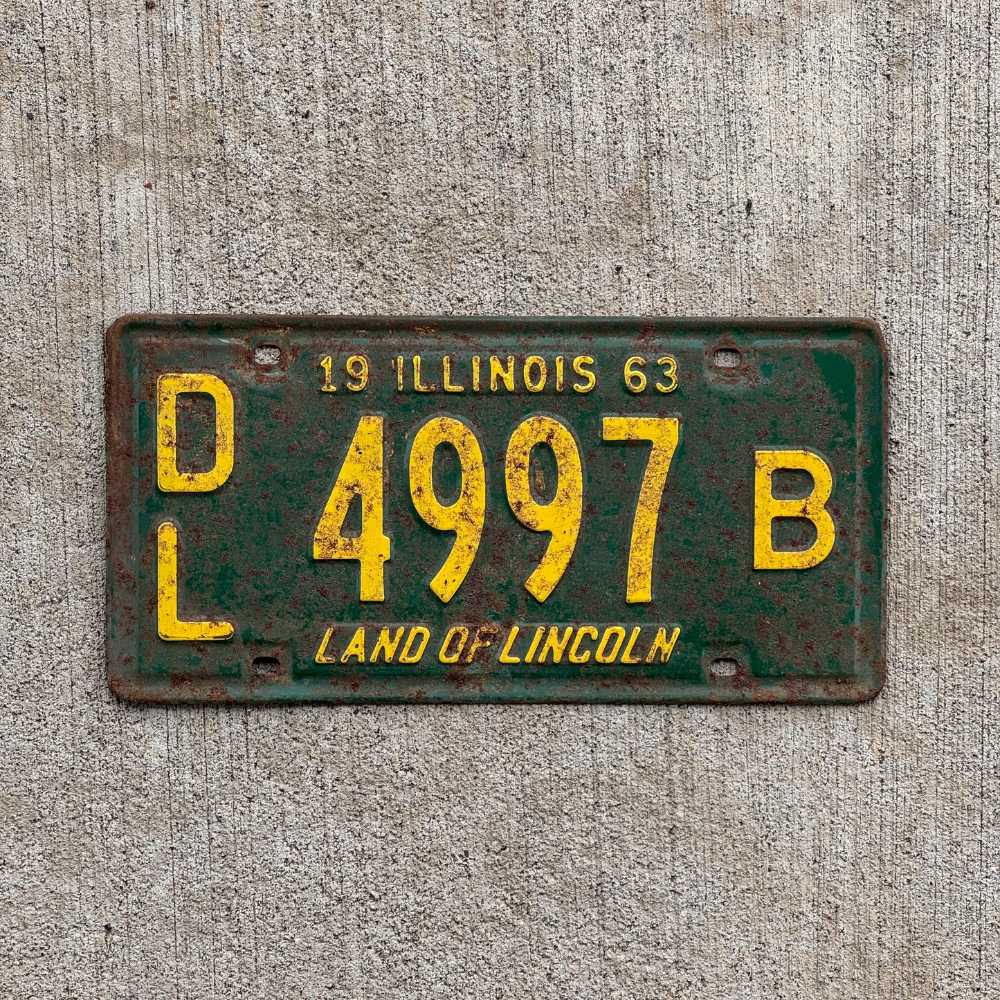 Photo of a 1963 Illinois Dealer License Plate Auto Tag 1 Vintage Garage 4997 B with original patina