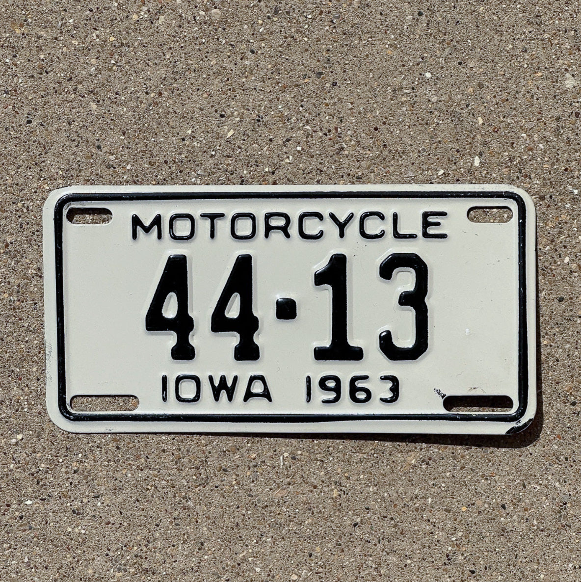 Photo of a 1963 Iowa Motorcycle License Plate Auto Tag Garage Decor Low Number Two Digit Henry County 44 13 with original patina
