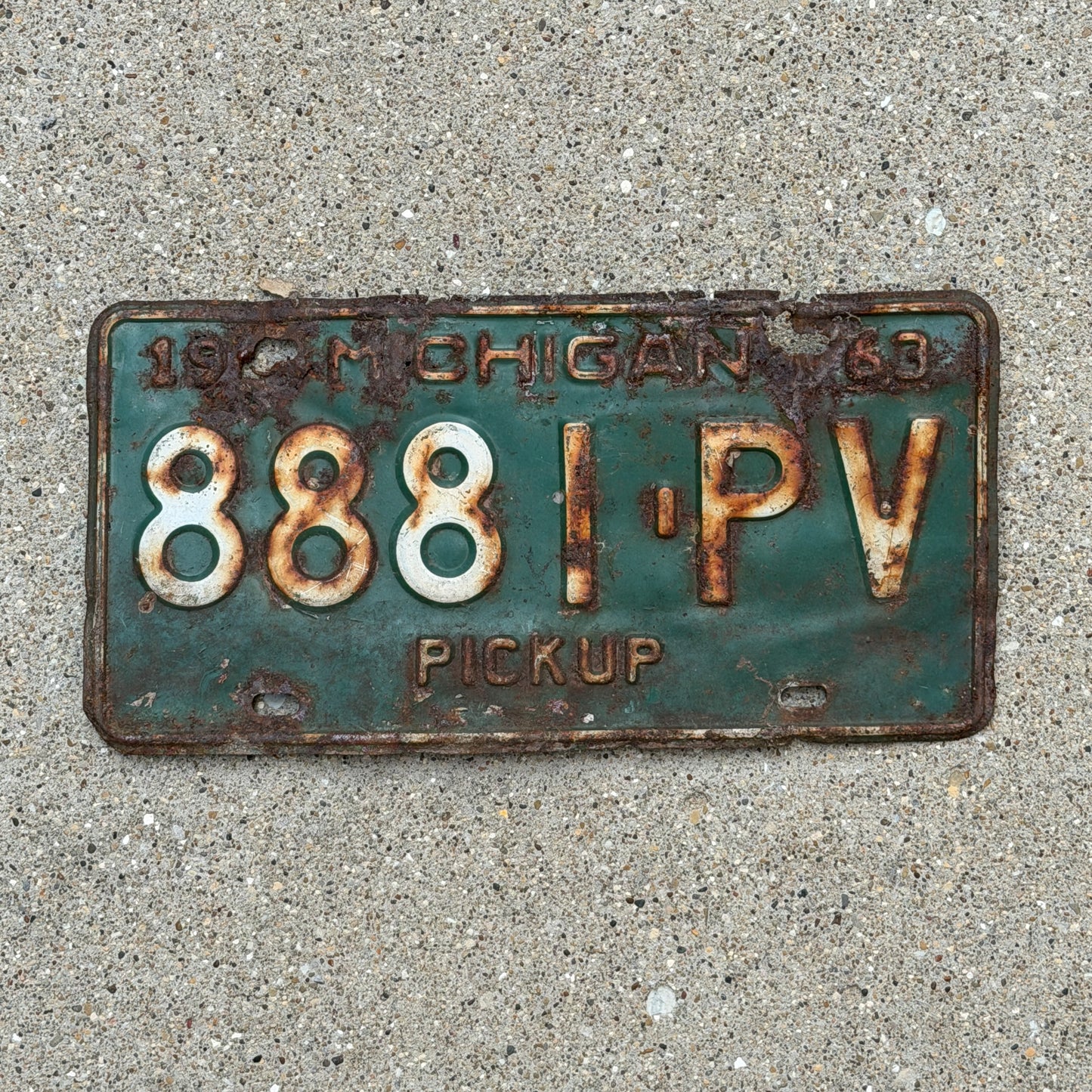 Photo of a 1963 Michigan Truck License Plate Auto Tag Garage Decor Vintage Pickup 8881 PV with original patina