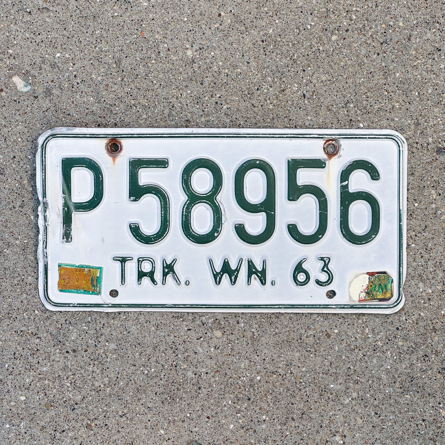 Photo of a 1963 Washington Truck License Plate Auto Tag Garage Decor Vintage DMV Clear Number P 58956 with original patina