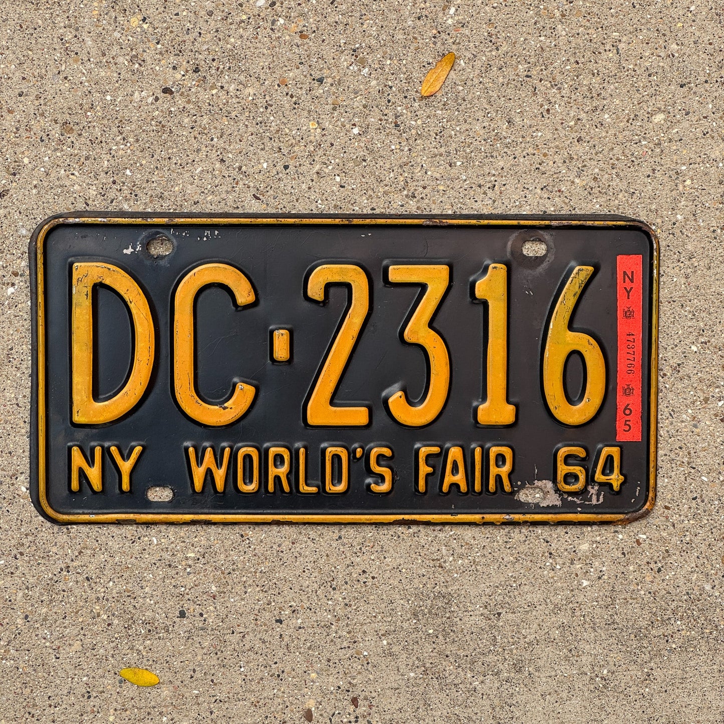Photo of a 1964 1965 New York License Plate Auto Tag Garage Decor Vintage World's Fair DC 2316 with original patina