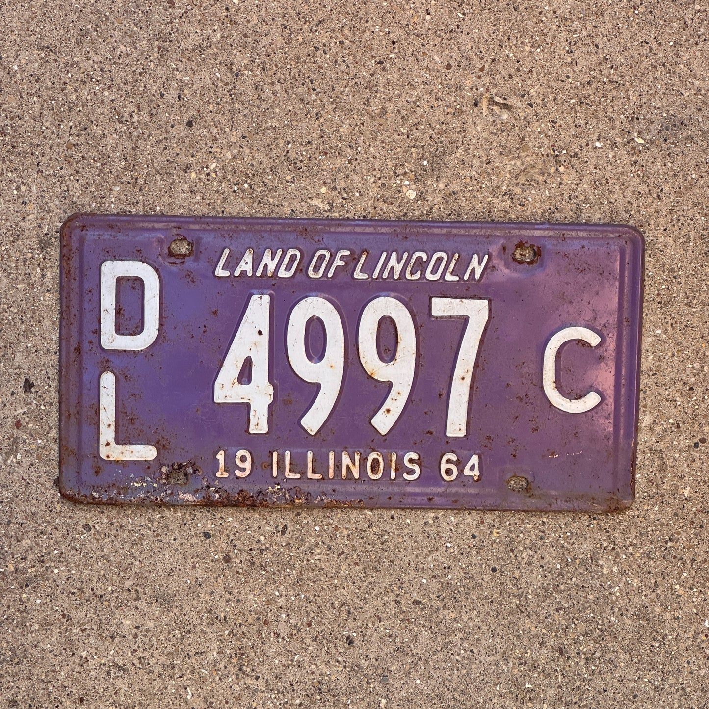 Photo of a 1964 Illinois Dealer License Plate Auto Tag 1 Vintage Garage Purple 4997 C with original patina