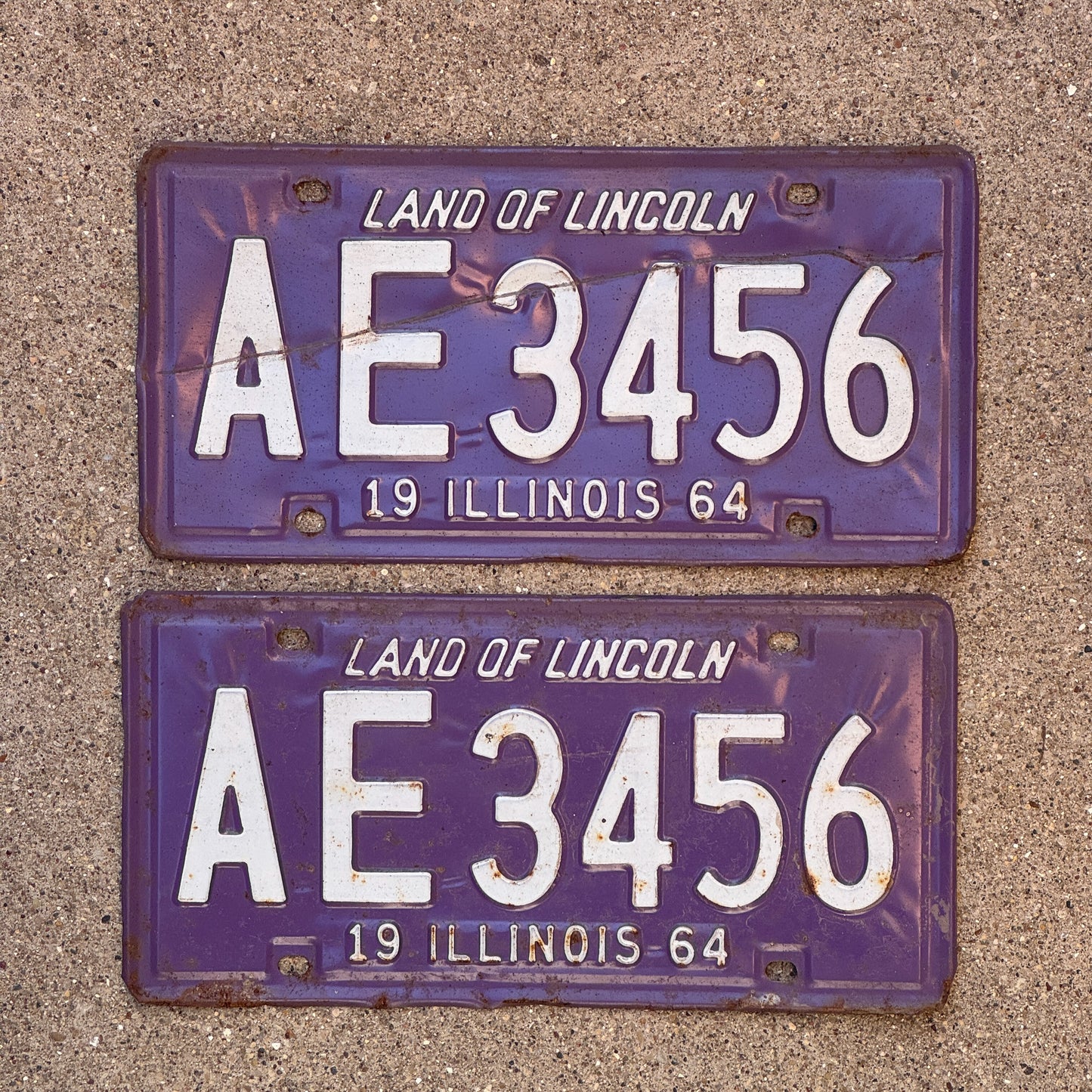 Photo of a 1964 Illinois License Plate Pair Auto Tag Garage Decor Vintage Straight Run Purple AE 3456 with original patina