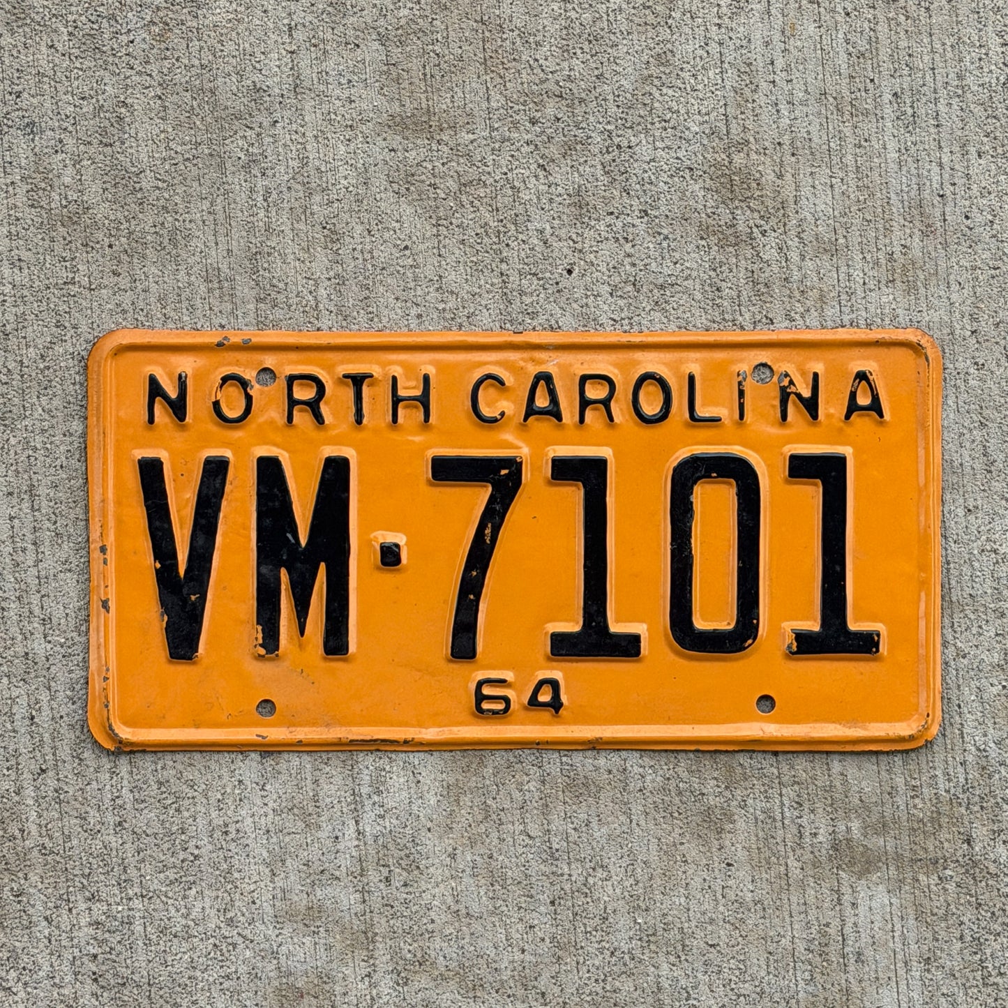 Photo of a 1964 North Carolina License Plate Auto Tag Garage Decor Vintage VM 7101 with original patina