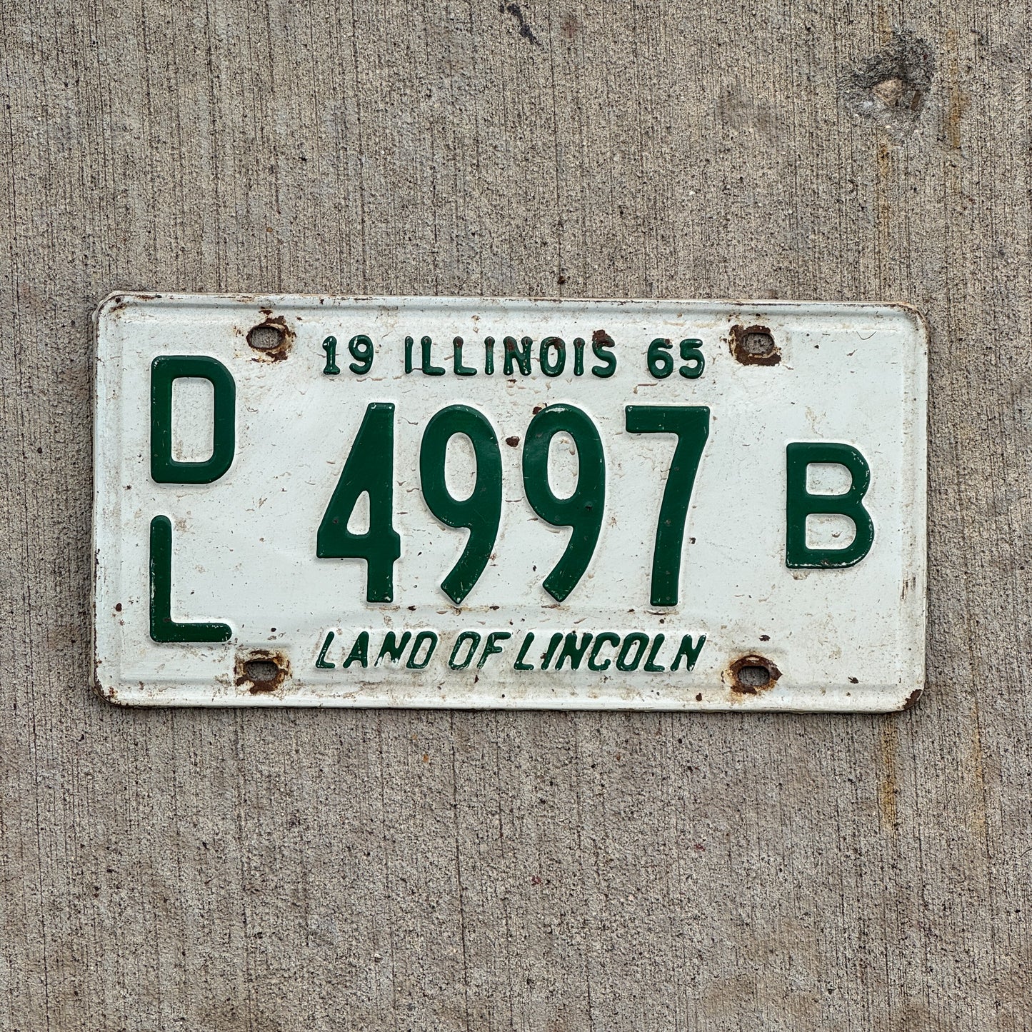 Photo of a 1965 Illinois Dealer License Plate Auto Tag 1 Vintage Garage 4997 B with original patina