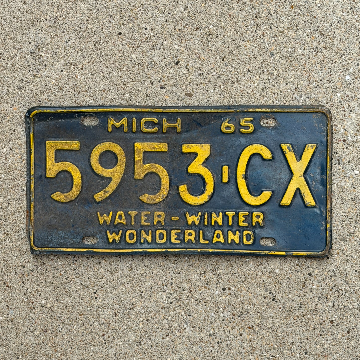 Photo of a 1965 Michigan Commercial License Plate Auto Tag Garage Decor Vintage 5953 CX with original patina