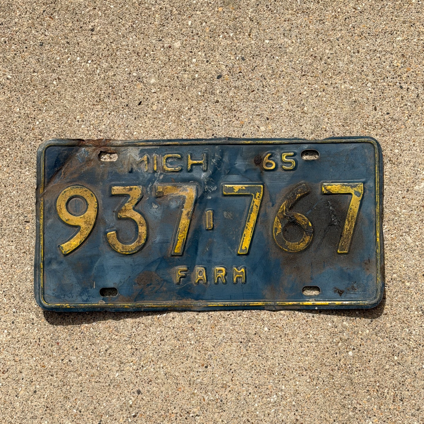 Photo of a 1965 Michigan Farm License Plate Auto Tag Garage Decor Vintage 937 767 with original patina