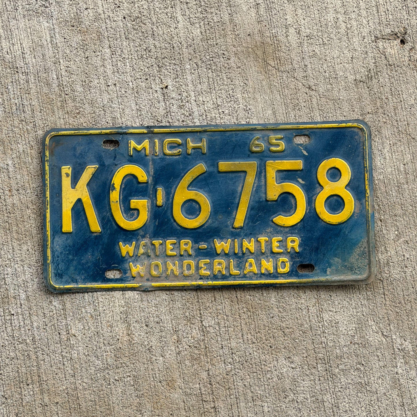 Photo of a 1965 Michigan License Plate Auto Tag Garage Decor Vintage KG 6758 with original patina