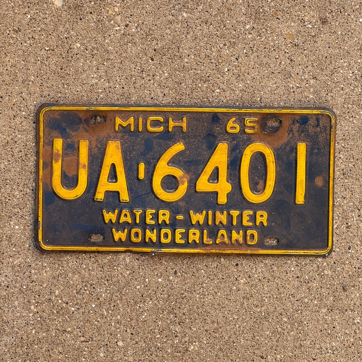 Photo of a 1965 Michigan License Plate Auto Tag Garage Decor Vintage UA 6401