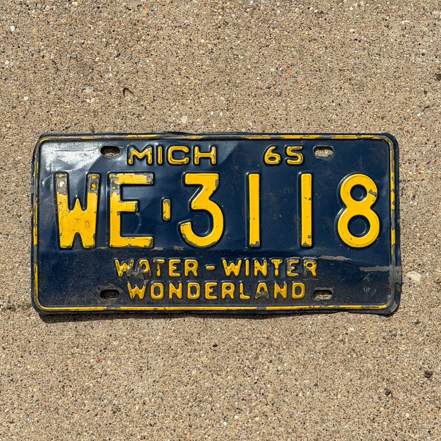 Photo of a 1965 Michigan License Plate Auto Tag Garage Decor Vintage WE 3118 with original patina