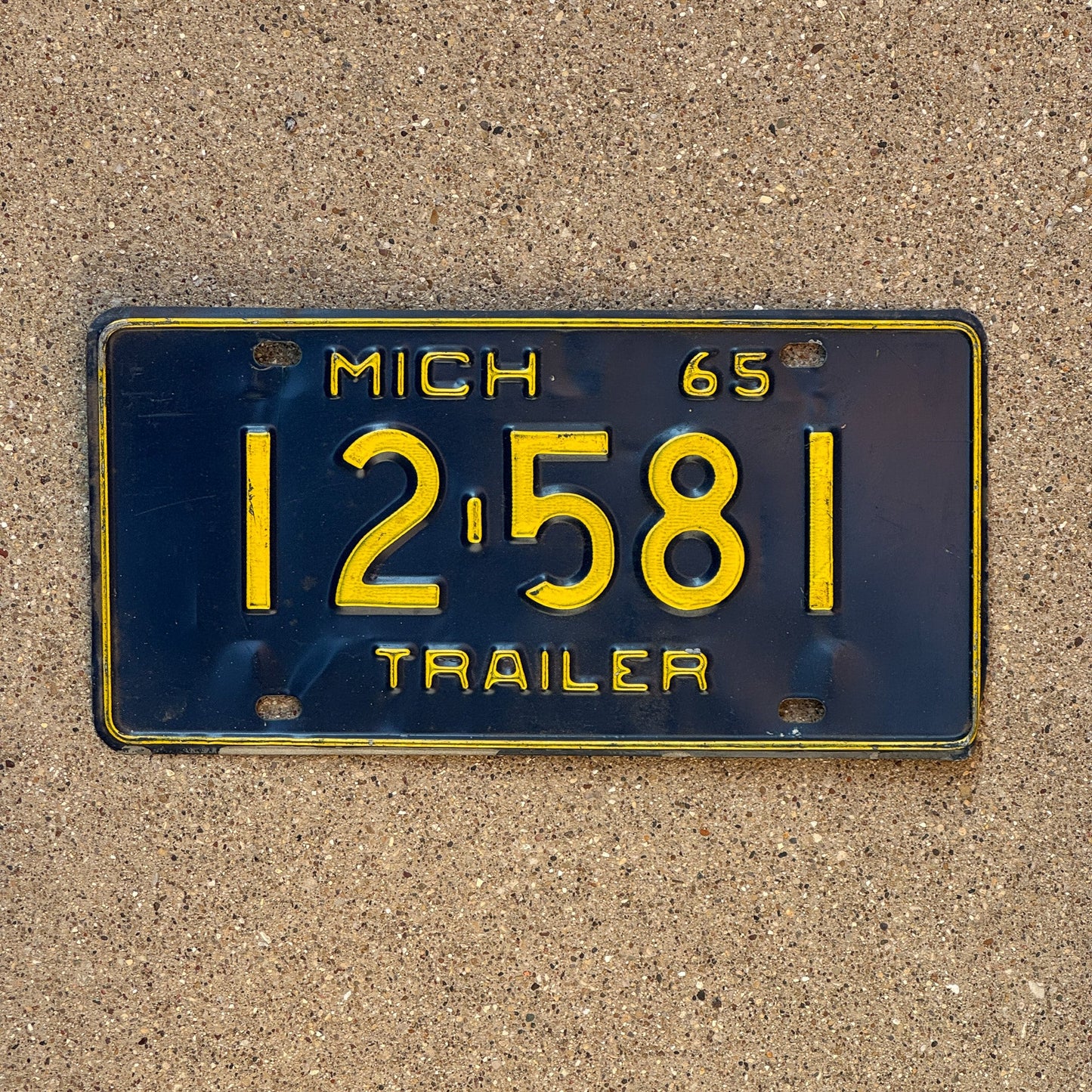 Photo of a 1965 Michigan Trailer License Plate Auto Tag Garage Decor Vintage 12 581