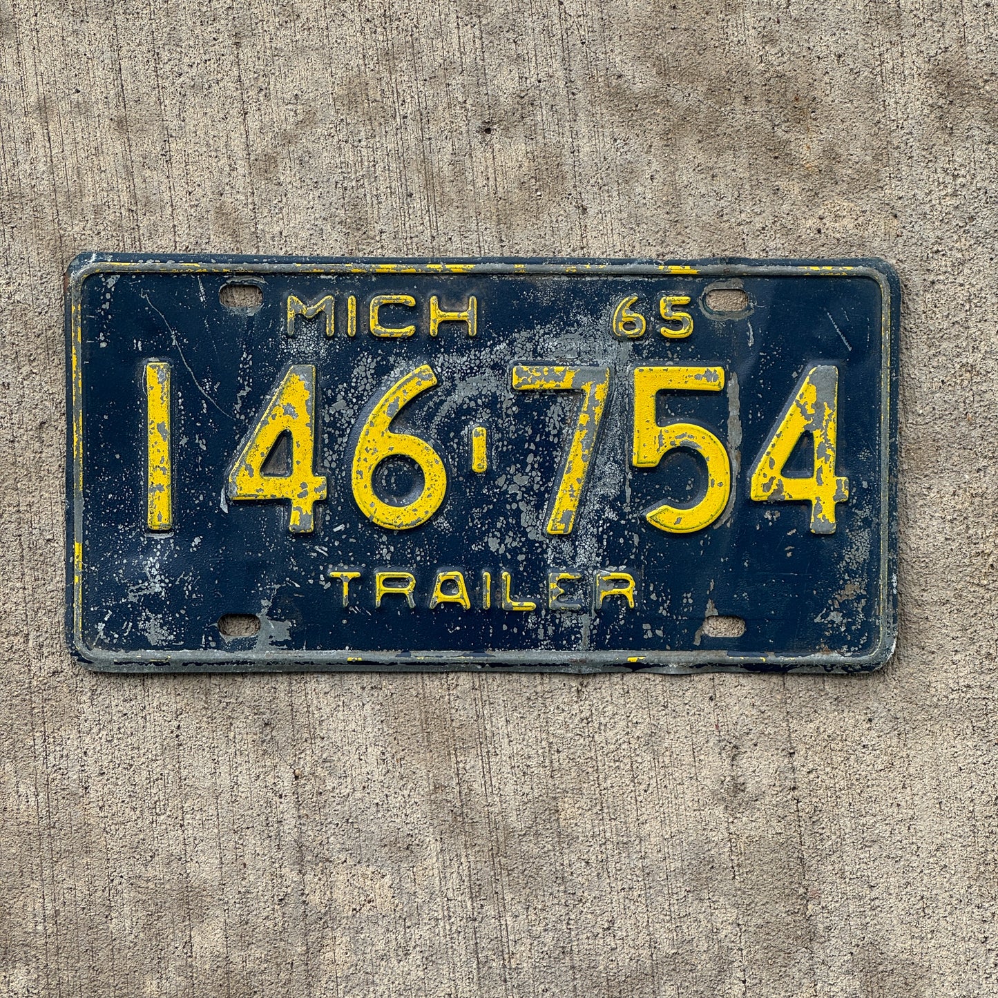 Photo of a 1965 Michigan Trailer License Plate Auto Tag Garage Decor Vintage 146 754 with original patina
