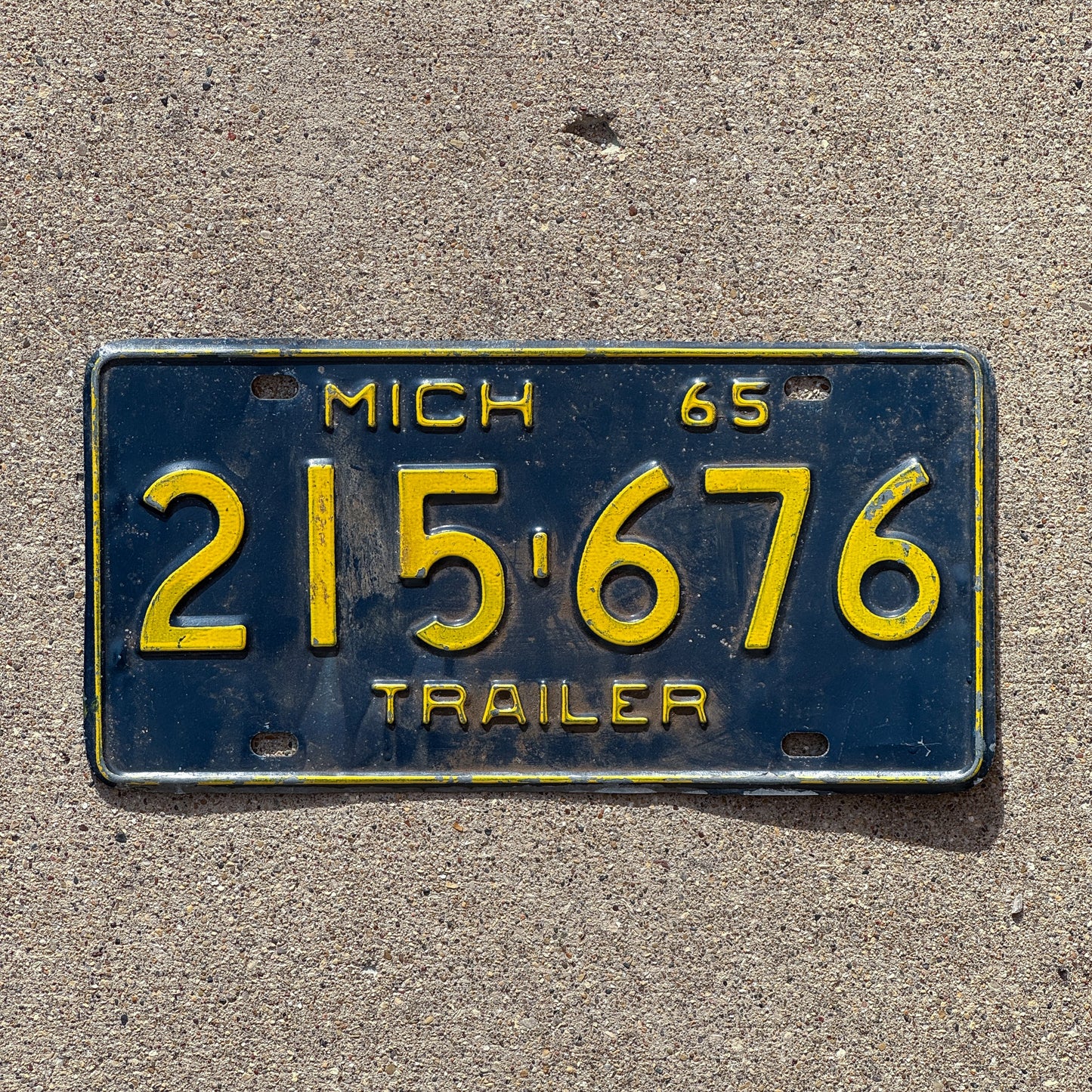 Photo of a 1965 Michigan Trailer License Plate Auto Tag Garage Decor Vintage 215 676 with original patina