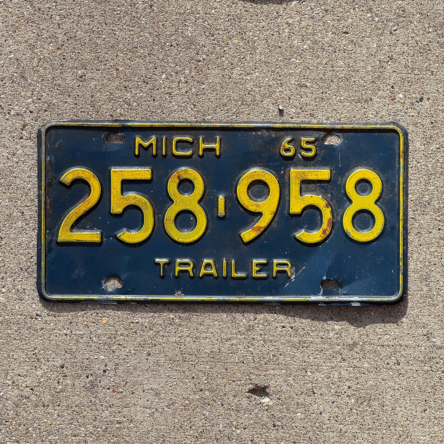 Photo of a 1965 Michigan Trailer License Plate Auto Tag Garage Decor Vintage 258 958 with original patina