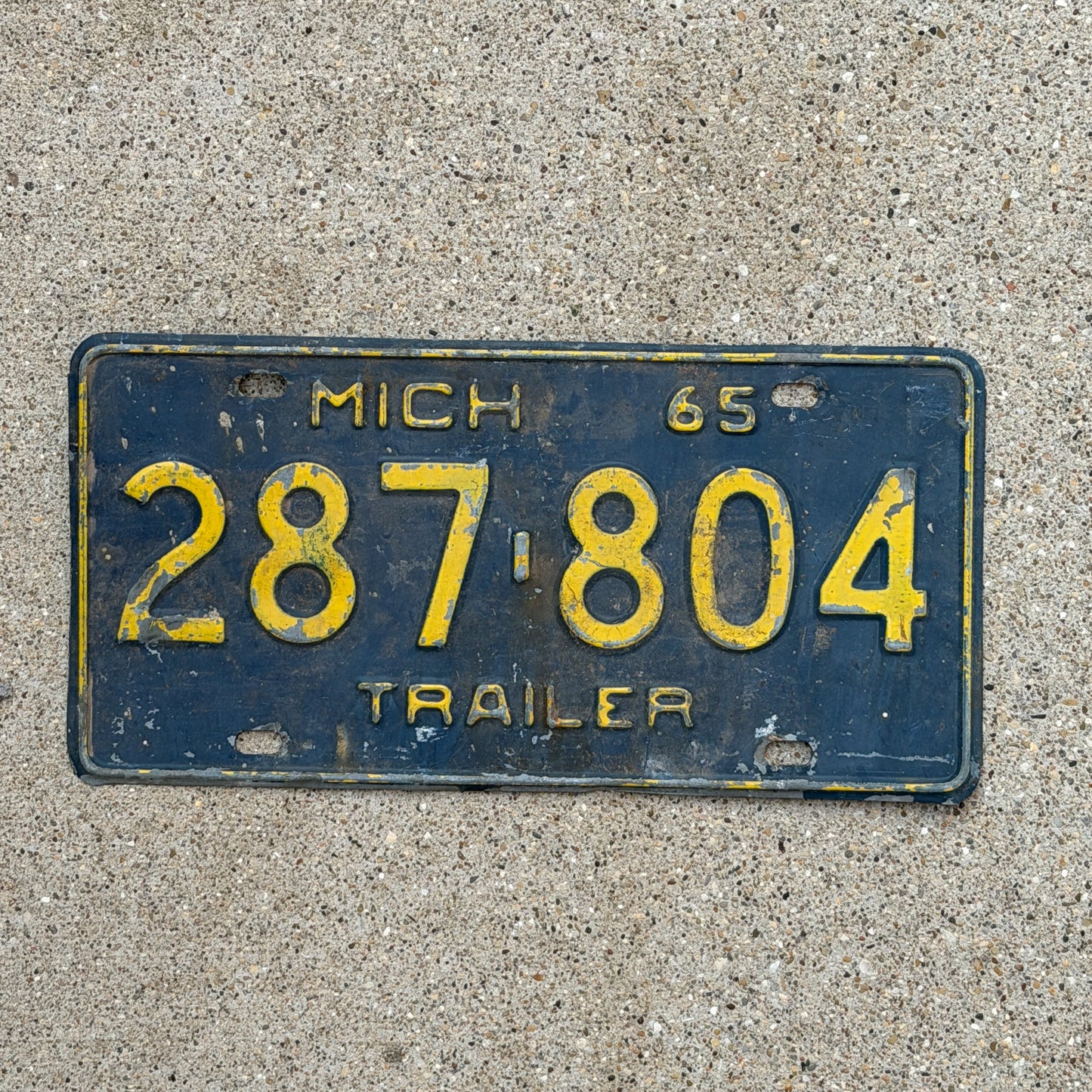 Photo of a 1965 Michigan Trailer License Plate Auto Tag Garage Decor Vintage 287 804 with original patina
