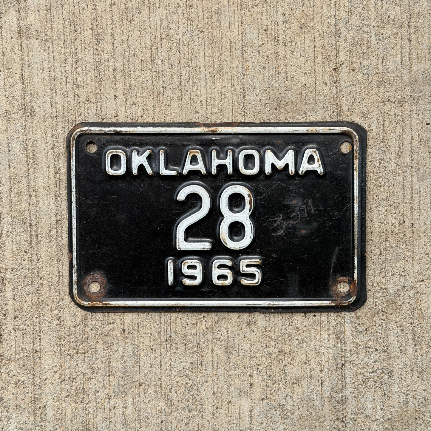 Photo of a 1965 Oklahoma Police Motorcycle License Plate Auto Tag Garage Decor Vintage Low Number Two Digit OKC Cop 28 with original patina