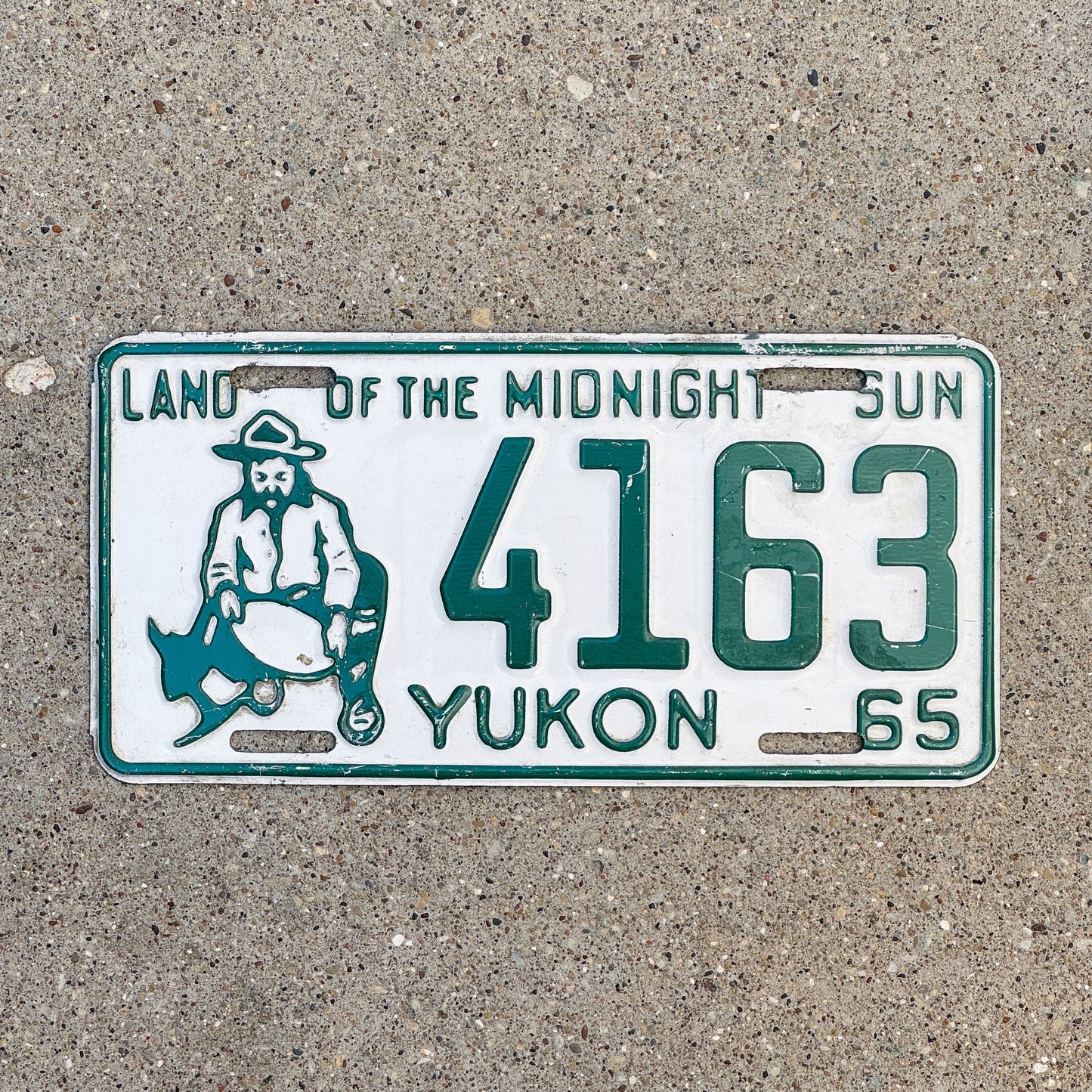 Photo of a 1965 Yukon License Plate Auto Tag Garage Decor Vintage Prospector 4163 with original patina